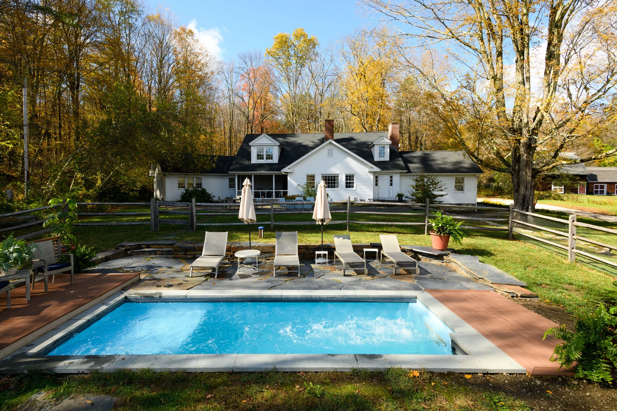 Heated swimming pool surrounded by gardens