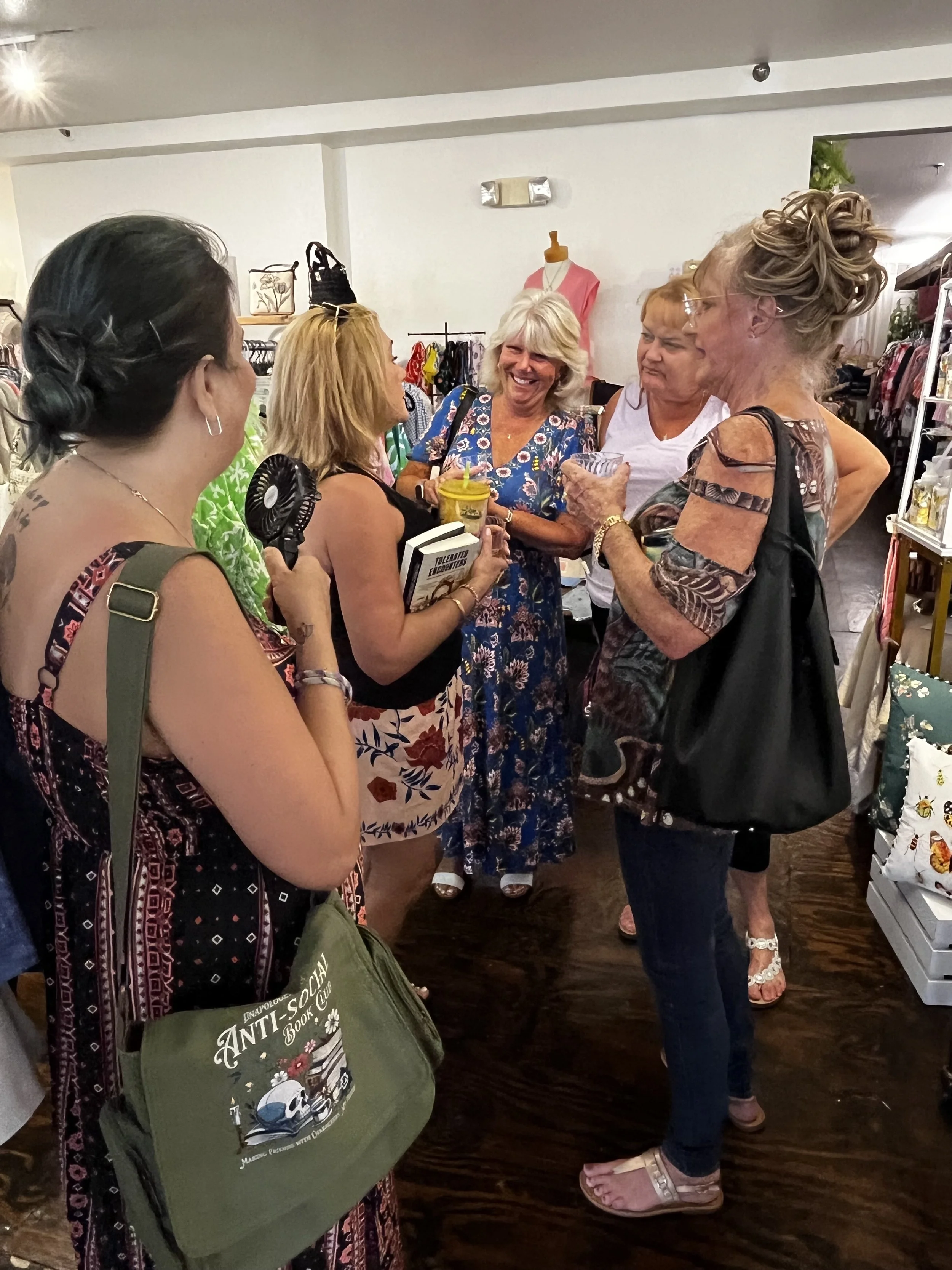 Attendees enjoying a luxury storytelling and shopping experience during Sip & Sign.