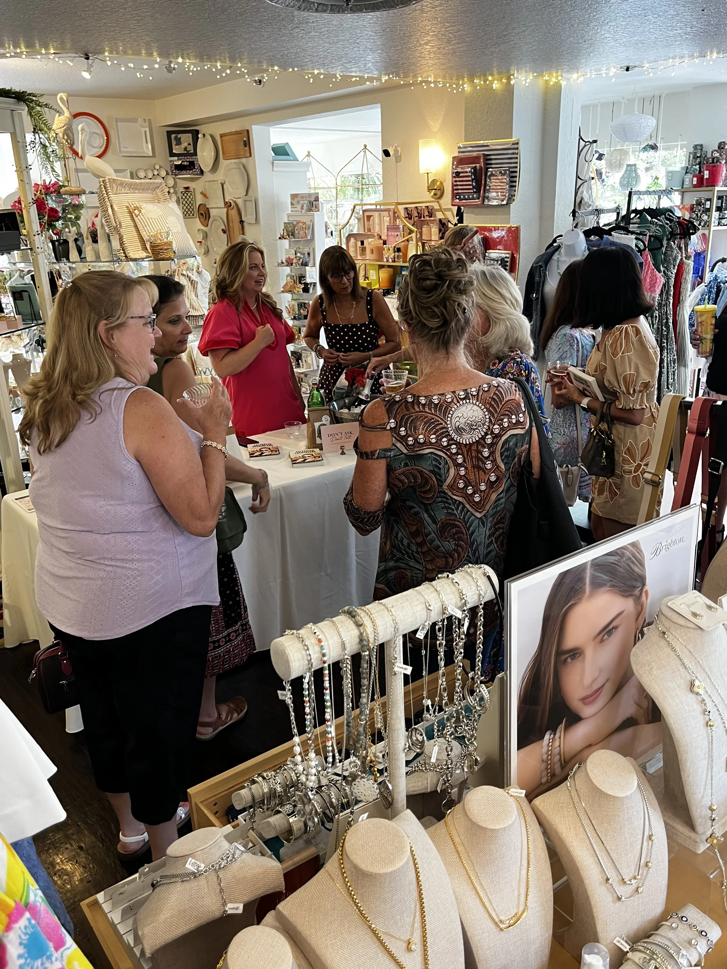 Guests shopping local boutique merchandise after attending a Sip & Sign experience.