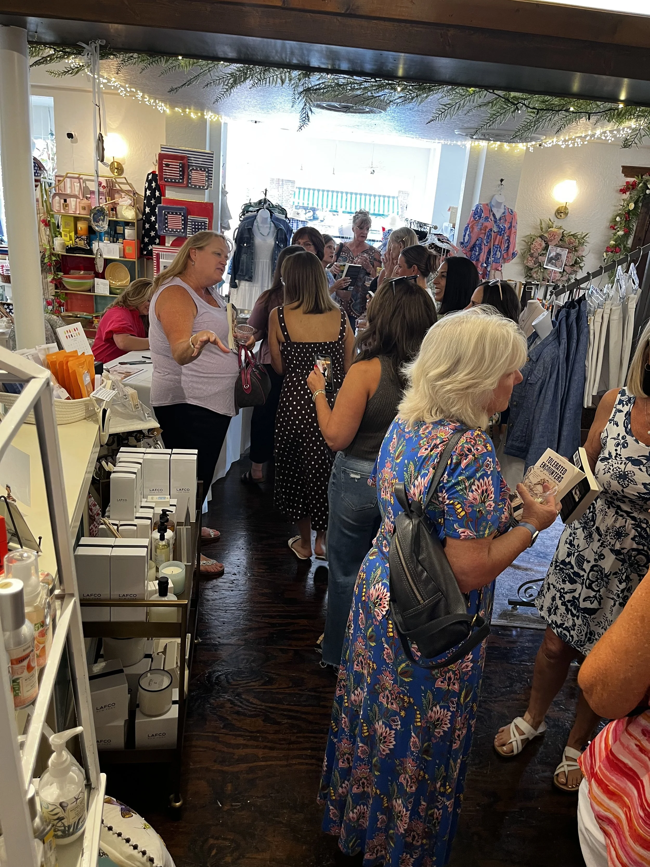 Attendees enjoying a luxury storytelling and shopping experience during Sip & Sign.