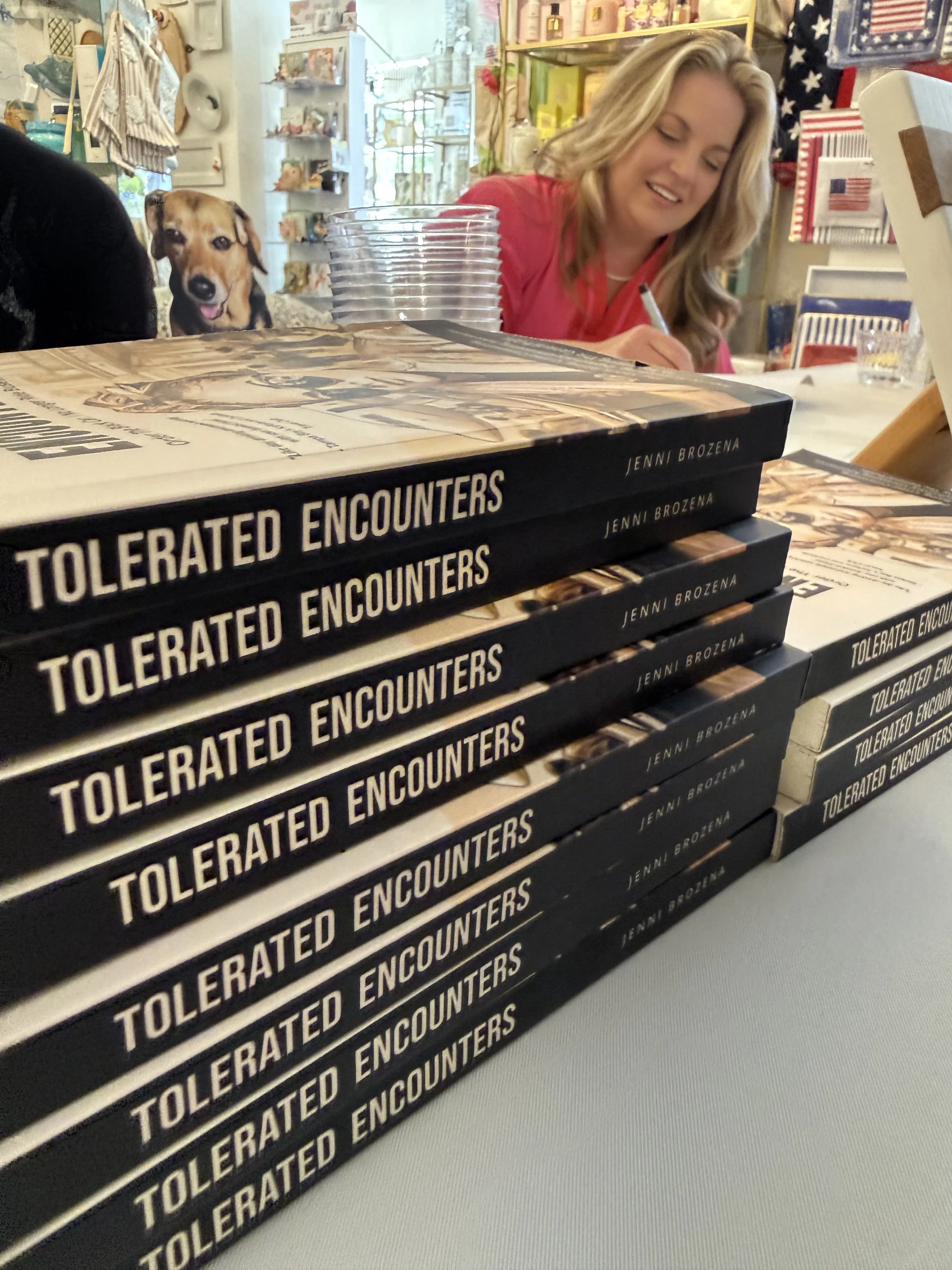 Author Jenni Brozena signing copies of Tolerated Encounters during a Sip & Sign event.