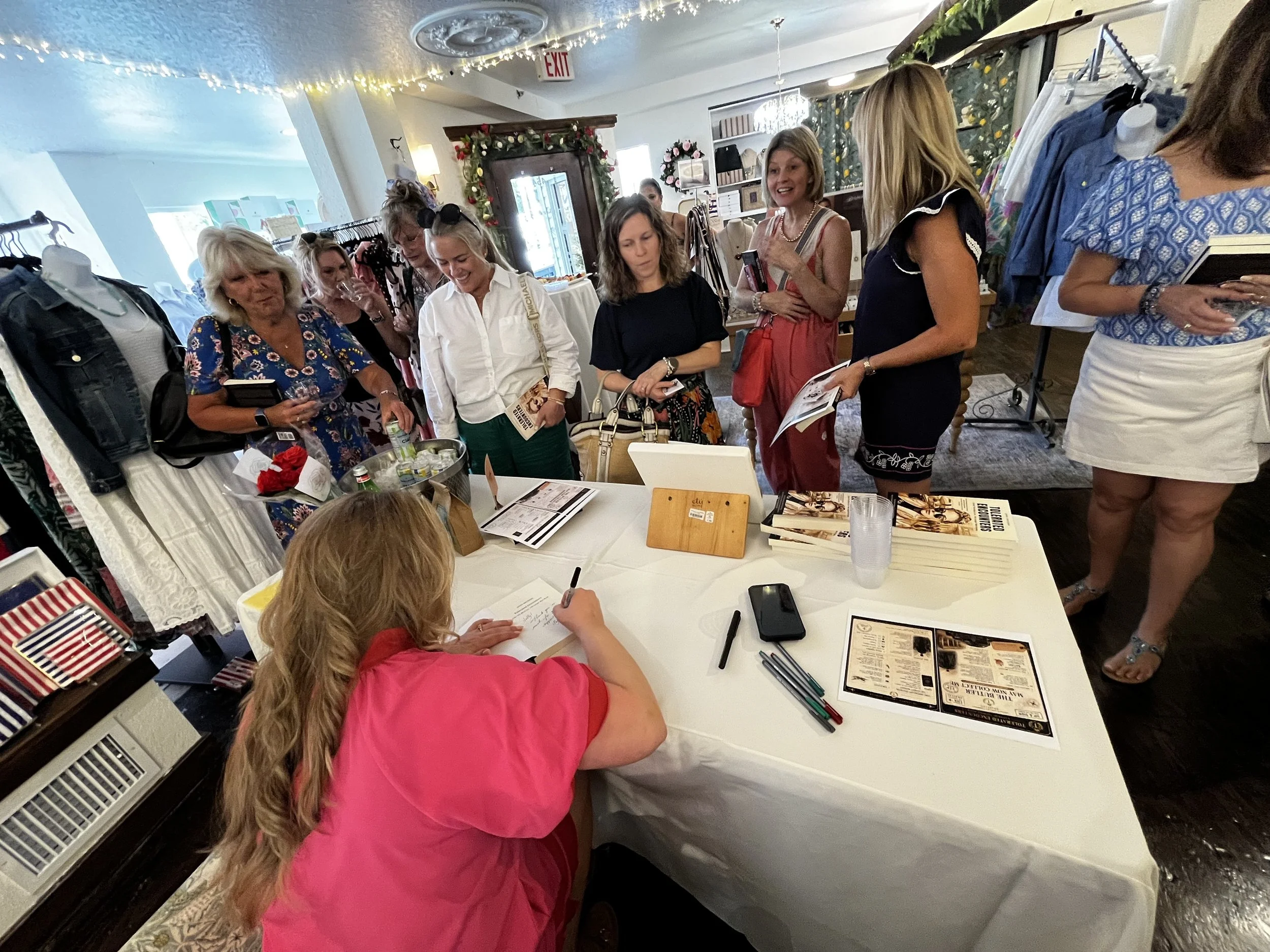 Author Jenni Brozena signing copies of Tolerated Encounters during a Sip & Sign event.