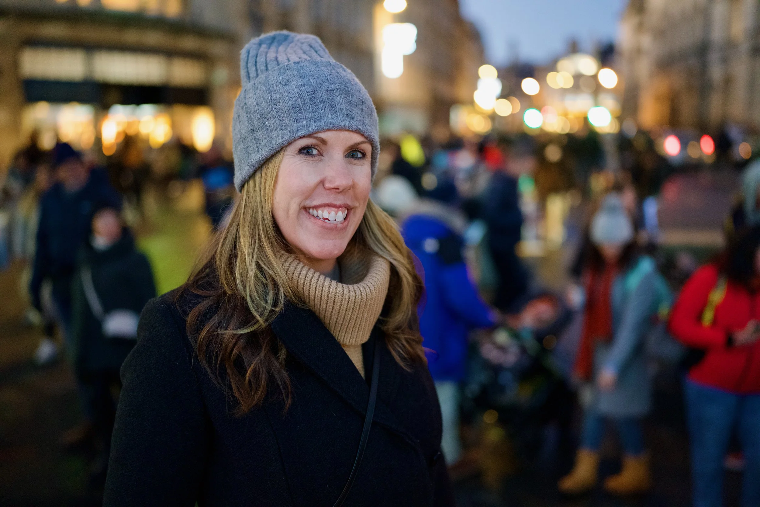 A woman, Brooke Van Dam, smiling looking into the camera wearing a grey beanie hat.