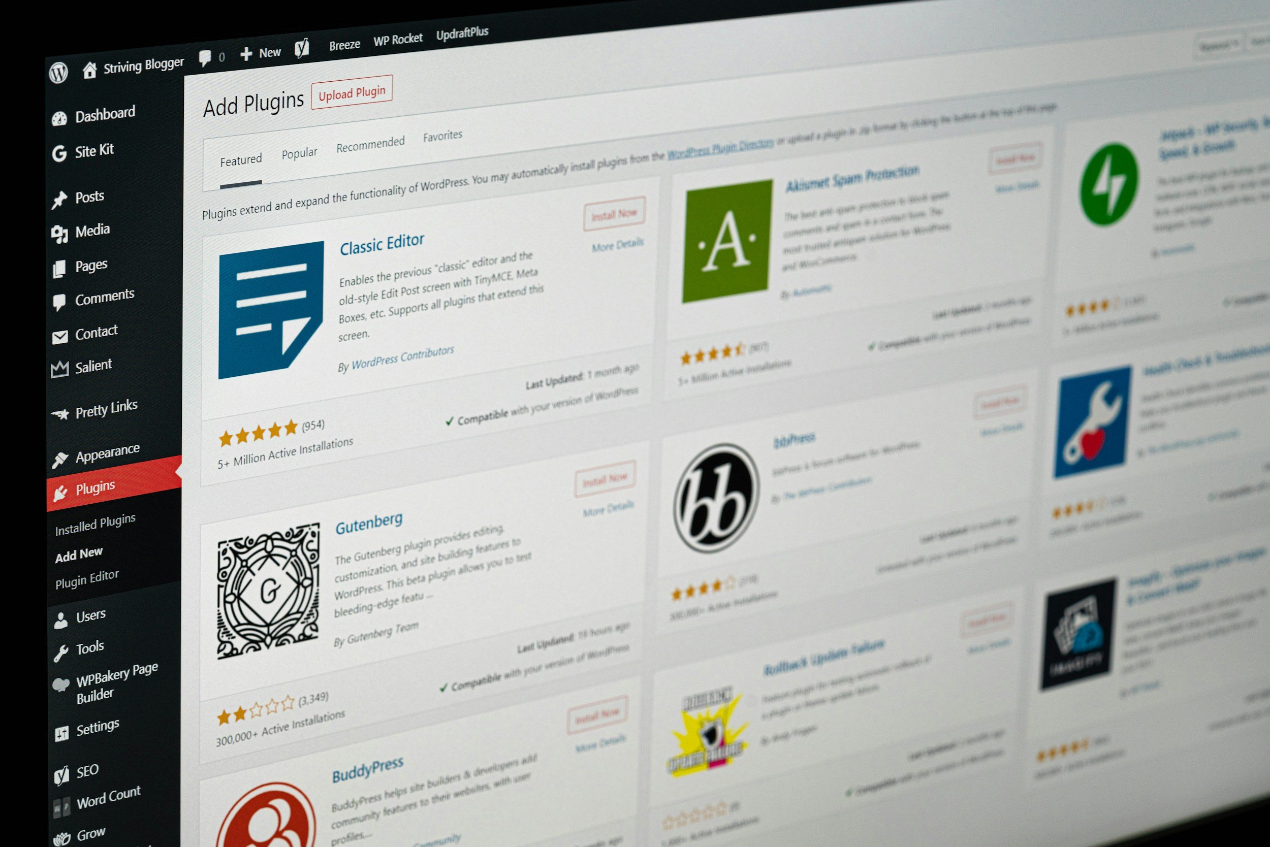 Screenshot of a WordPress dashboard page showing the plugin repository with various plugins listed, including Classic Editor, GeneratePress, BuddyPress, and others.