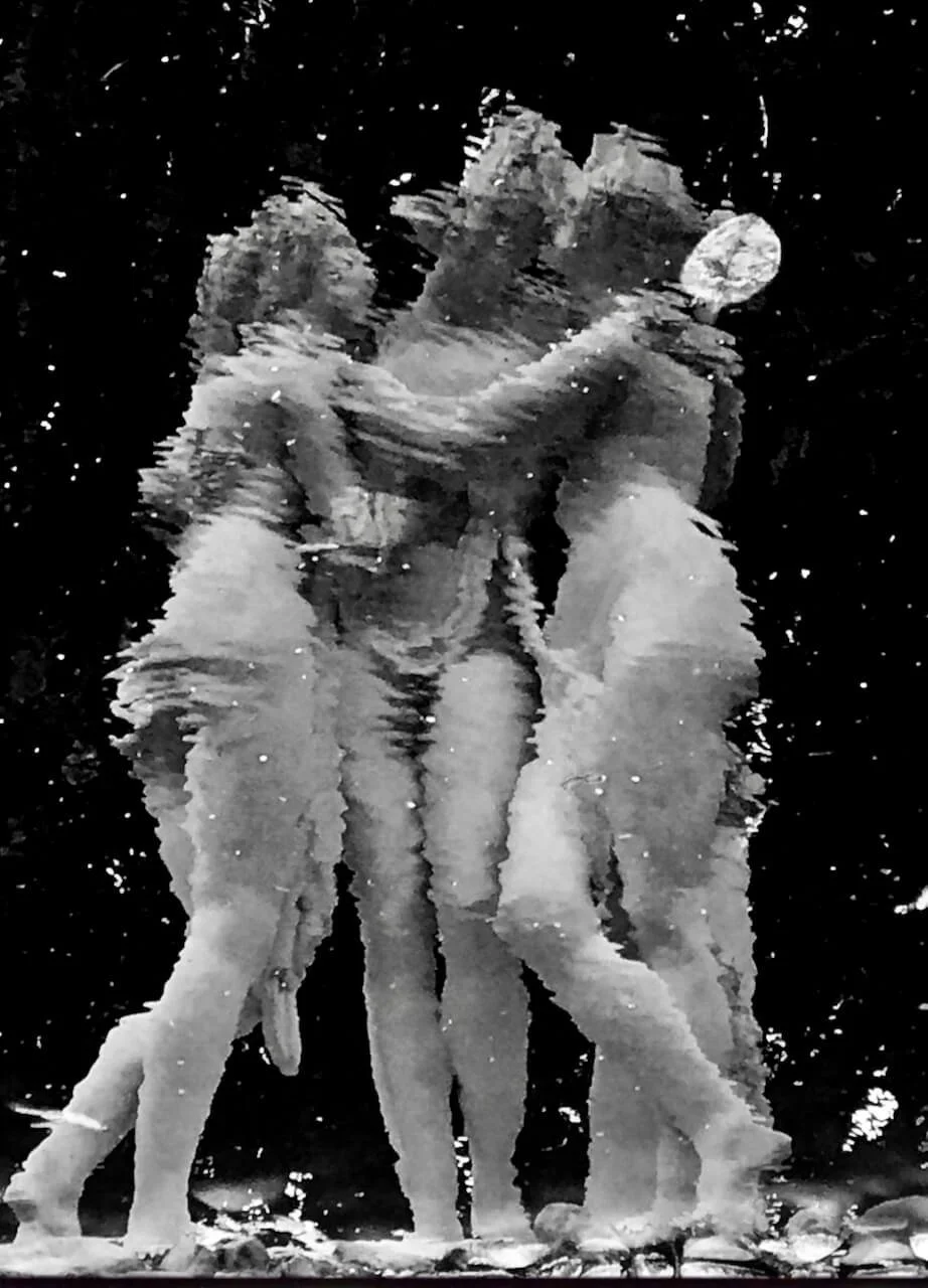 The Three Graces statue at Maymont, Richmond, Virginia, viewed distorted through rippling water