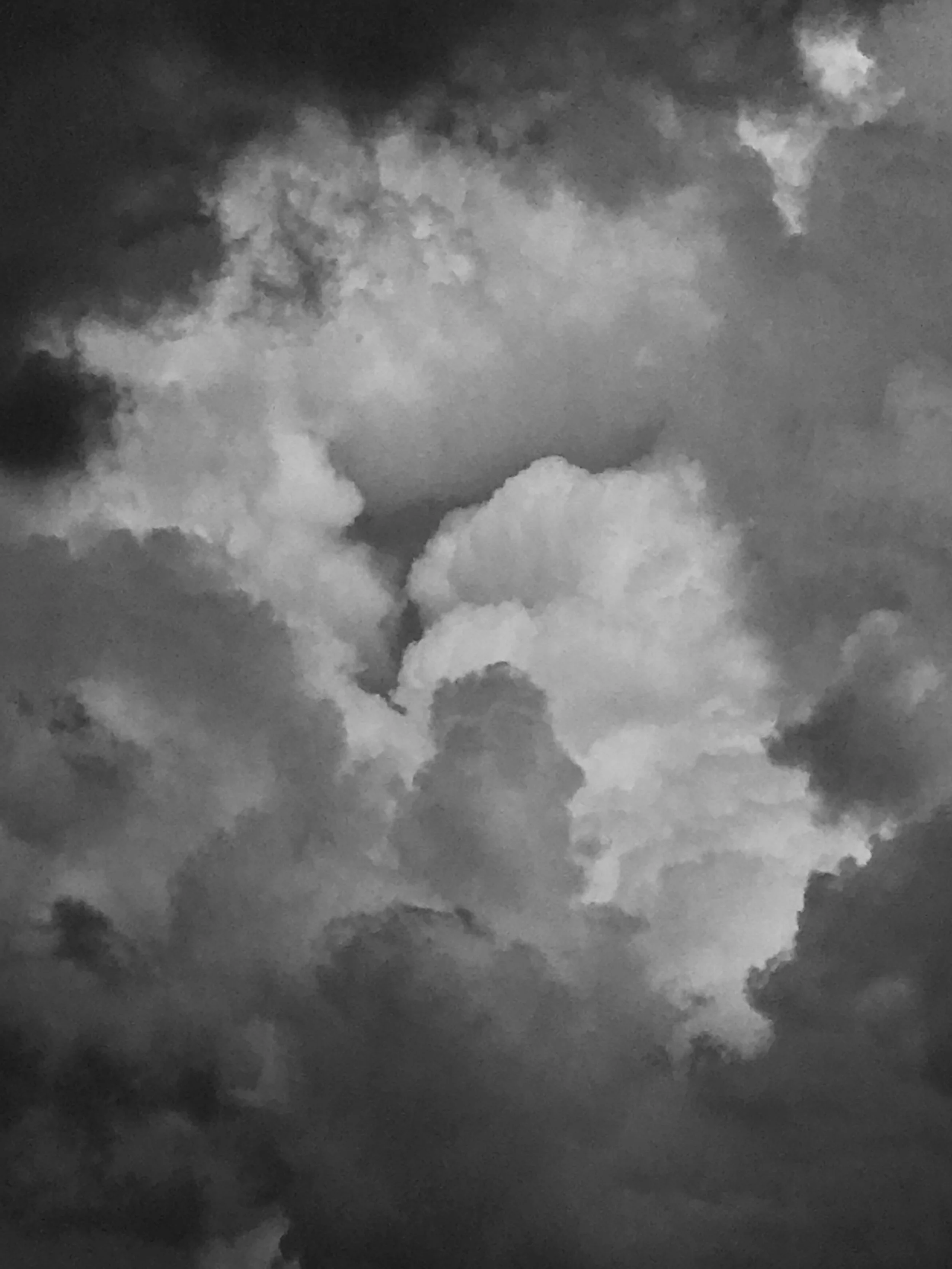 Black and white photo of a building summer thunderstorm sky formation with a tempest of clouds shapes