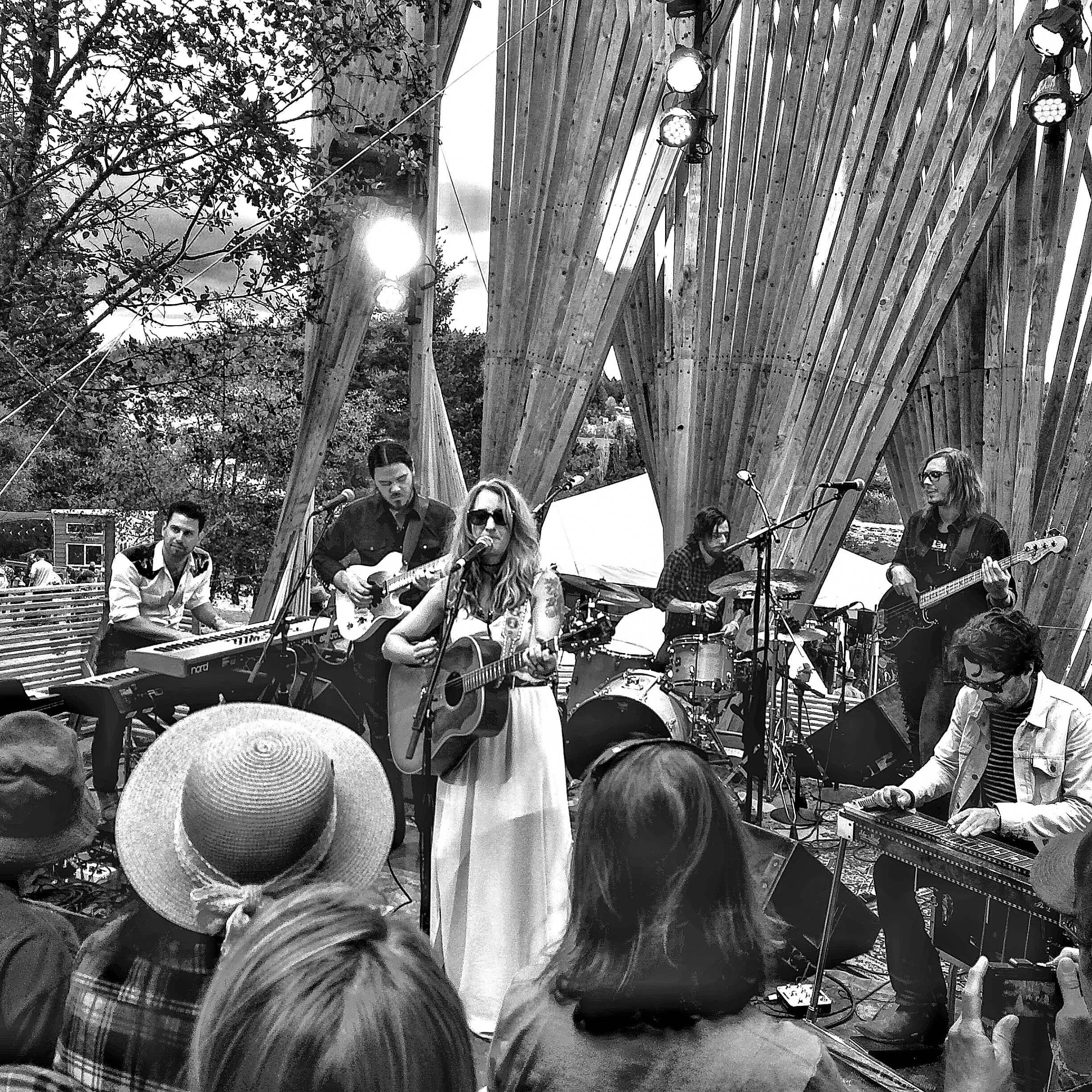 Black and white photo of Margo Price and her band on the Treeline Stage at Pickathon in Happy Valley, Oregon.  Performance from 2016.