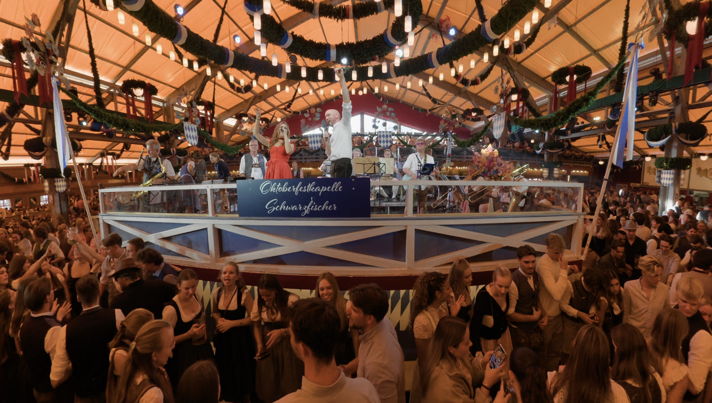 crowded beer tent Oktoberfest singing