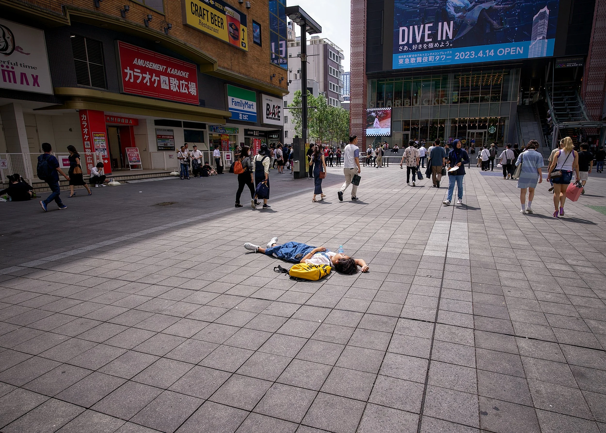 Man laying on ground in Japan