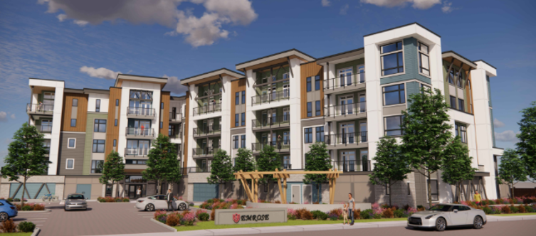 Modern multi-story residential apartment building with trees, parking lot, and people outdoors on a sunny day.