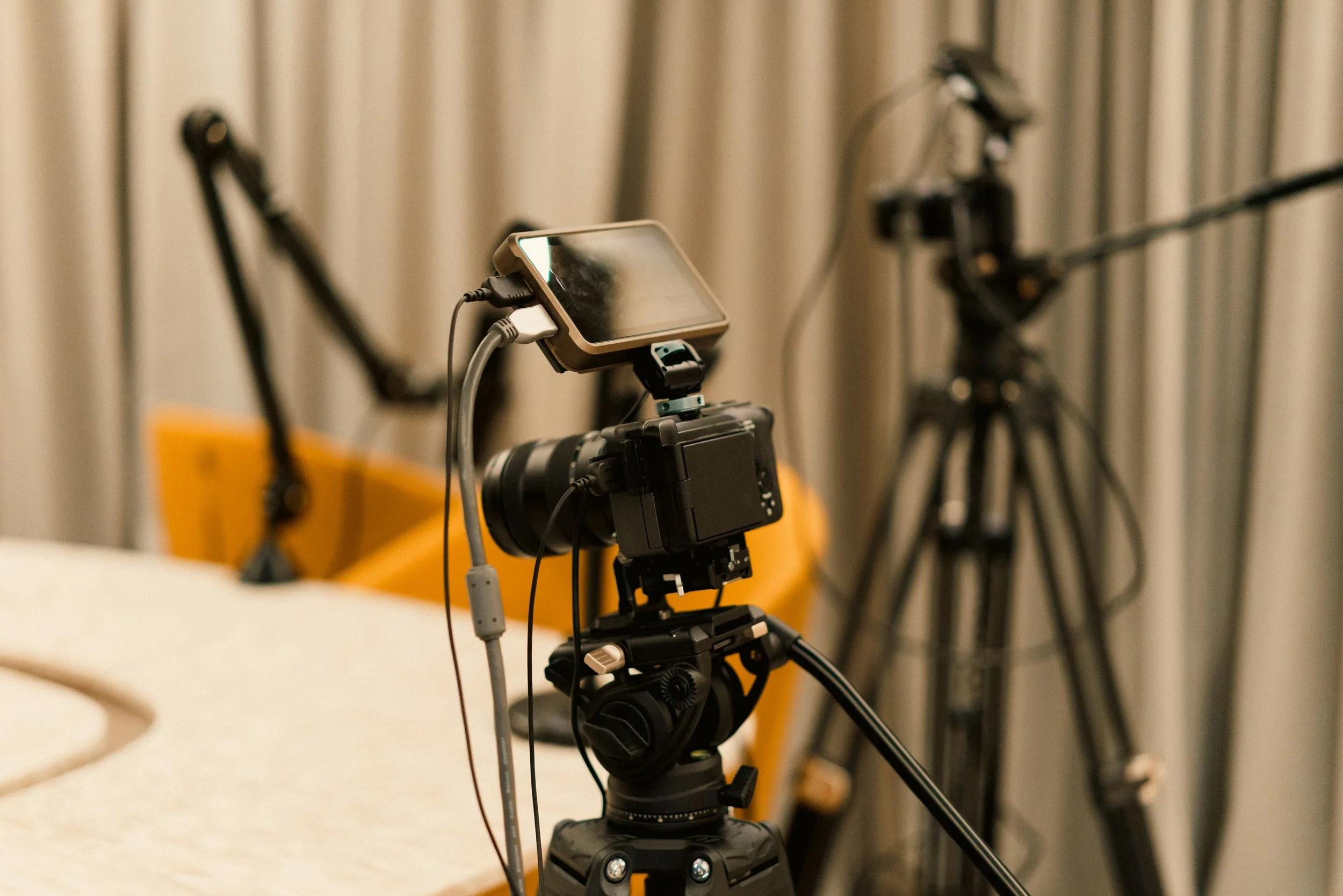 Professional video camera and podcast microphones prepared for recording