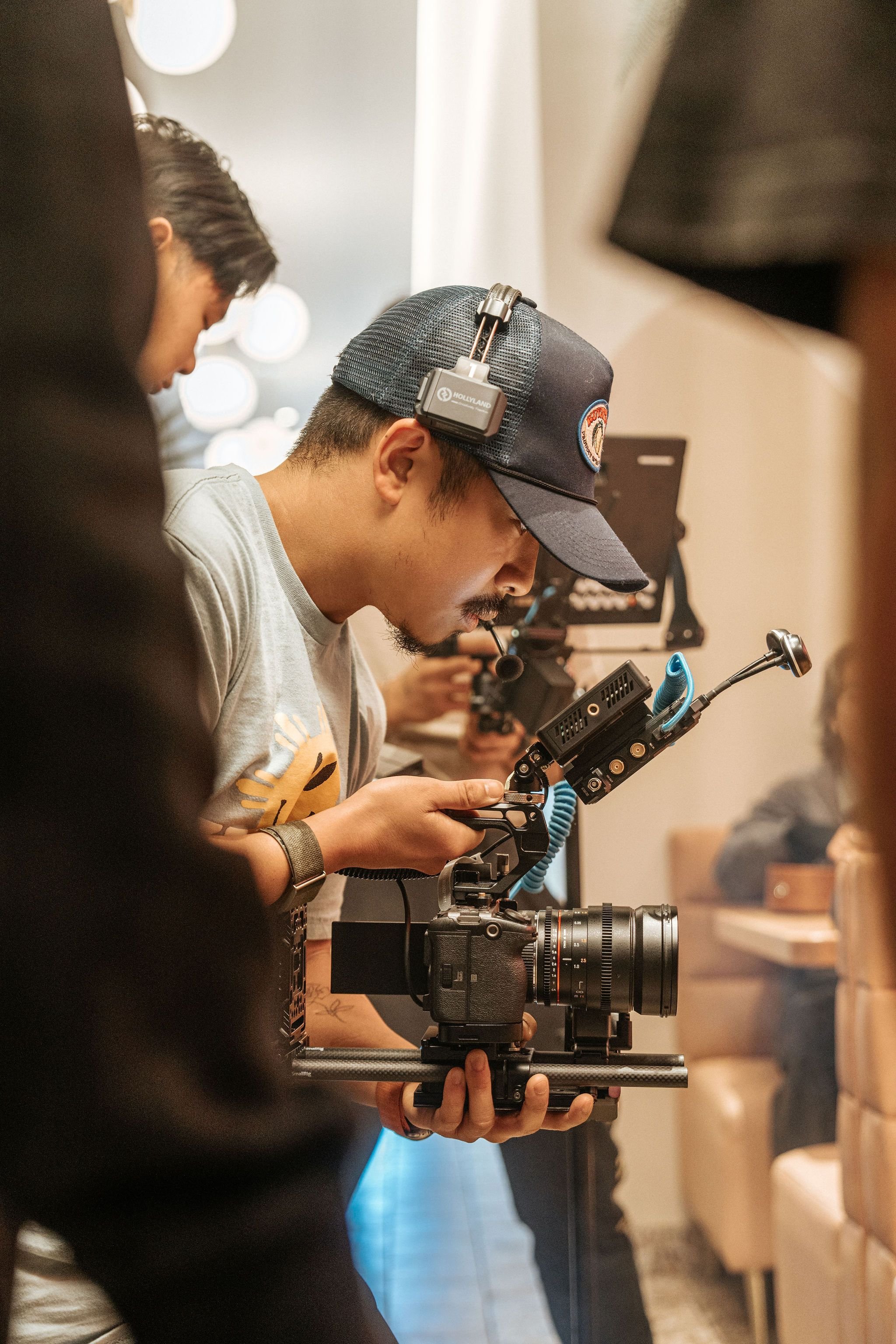 Production professional configuring a cinema camera and wireless video system
