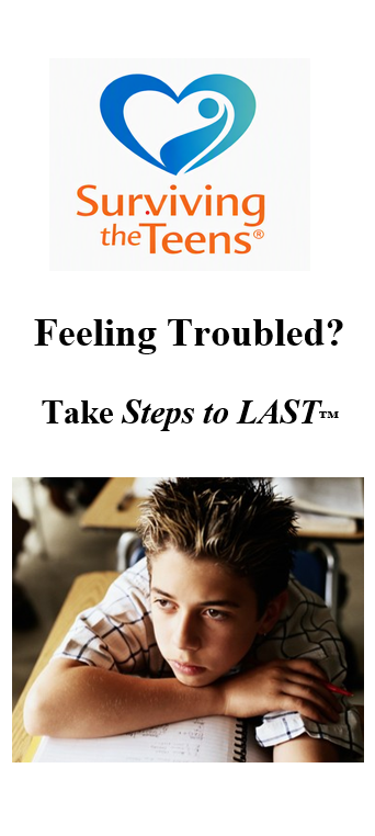 Teen boy resting his head on his arm at a desk.
