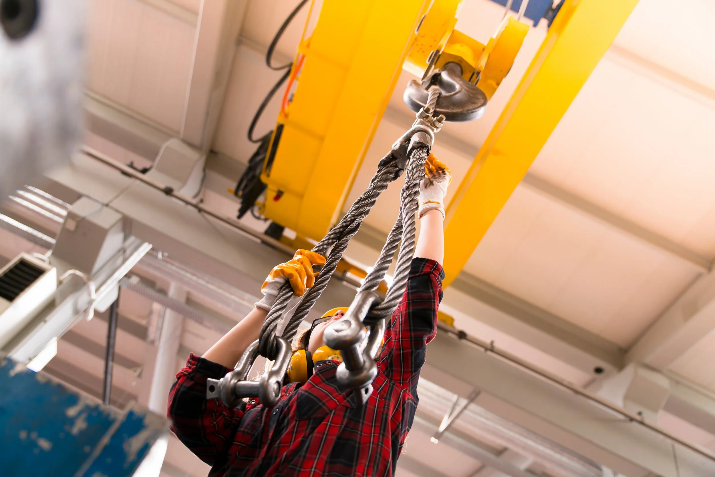 Technician completing repair to rope on hosit hook.