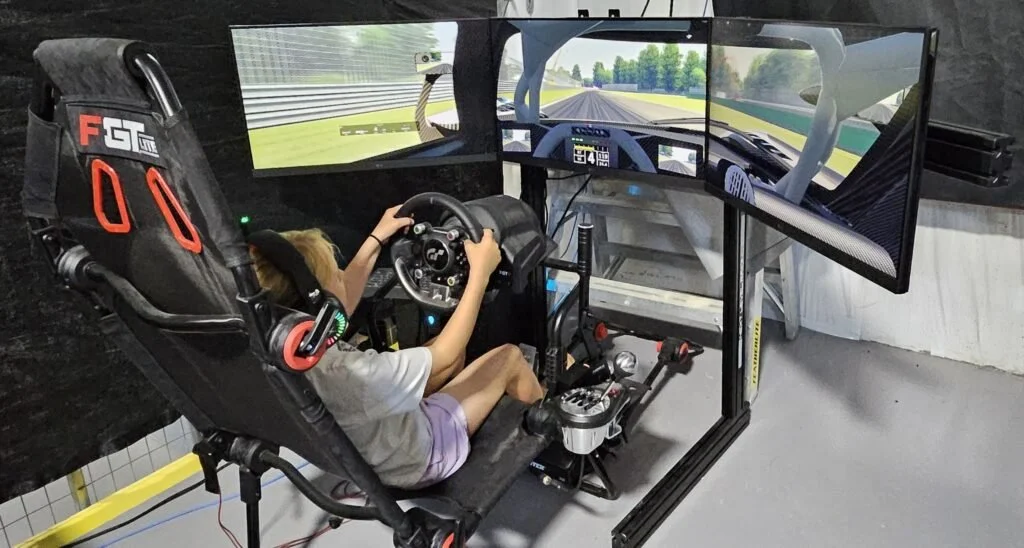 Student using a multi-screen driving simulator
