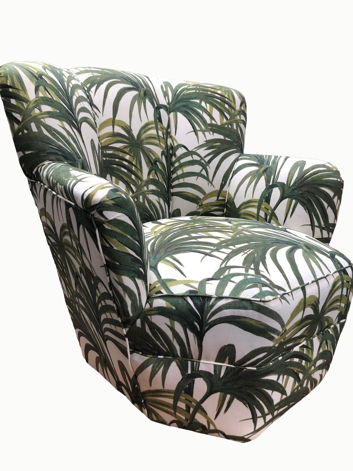 A patterned armchair with tropical leaf design in green and white colors.