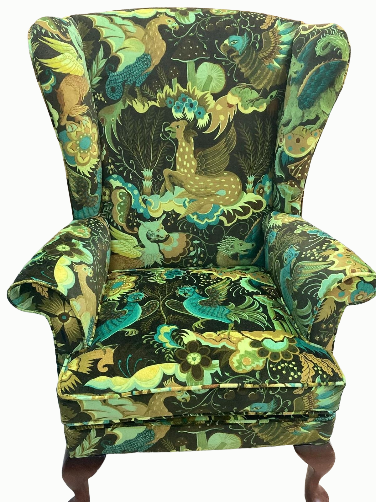 A high-backed armchair with a colorful tapestry upholstery featuring various stylized mythical and jungle animals, including lions, birds, and serpents, in vibrant green, blue, yellow, and brown colors.