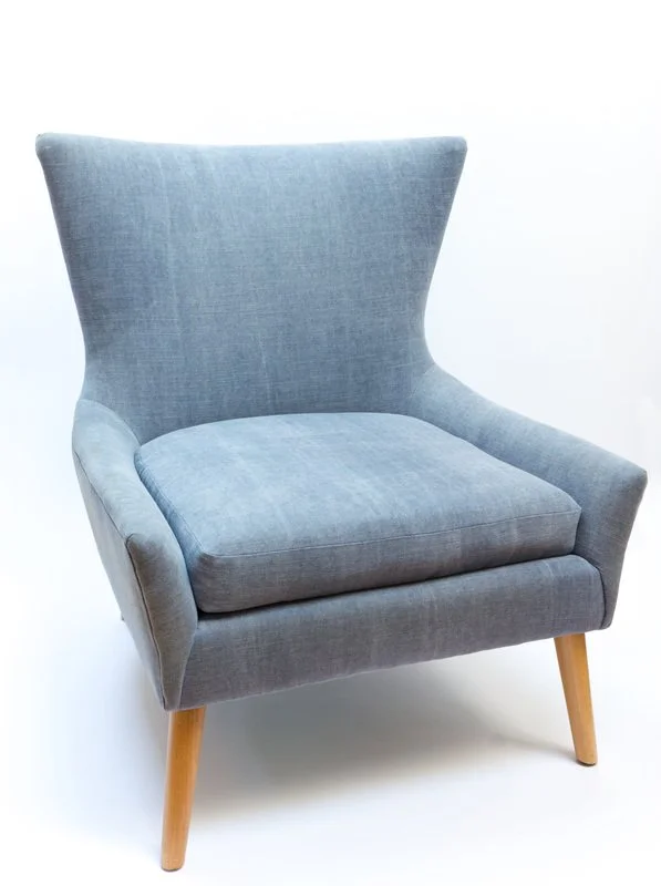 Gray upholstered armchair with wooden legs
