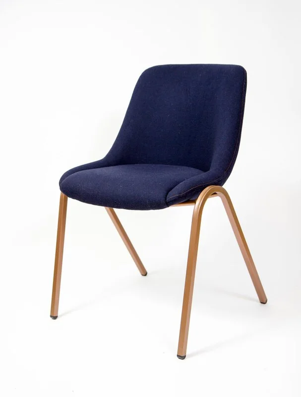 A modern upholstered navy blue chair with light wooden legs on a white background.