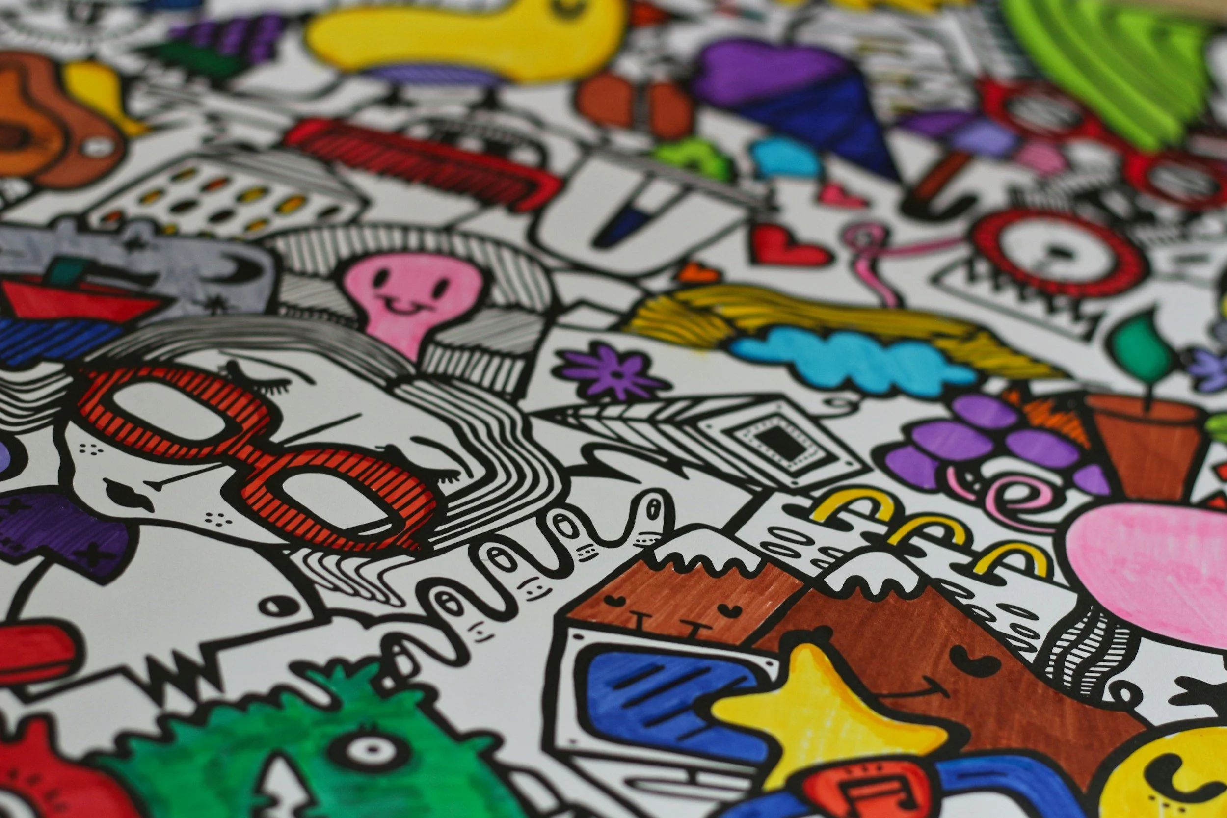 Close-up of a colorful doodle art illustration with various shapes, characters, and objects in vibrant colors.