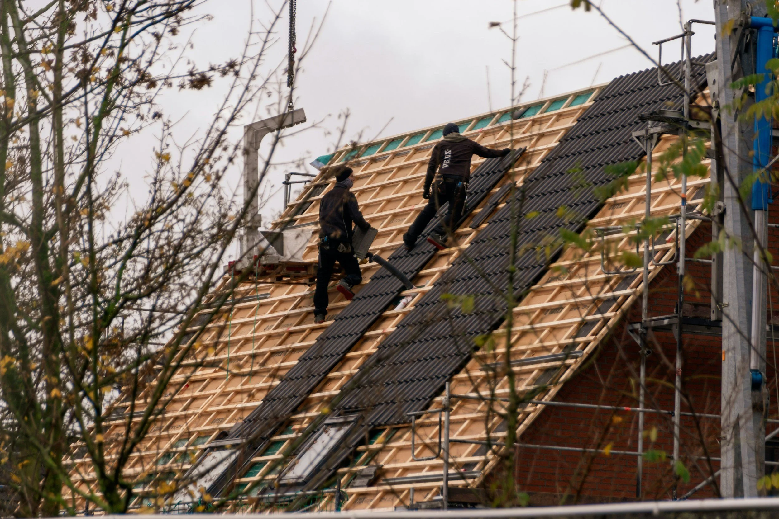 Roofing crew installing a new roof on a home after storm and hail damage in the Treasure Valley