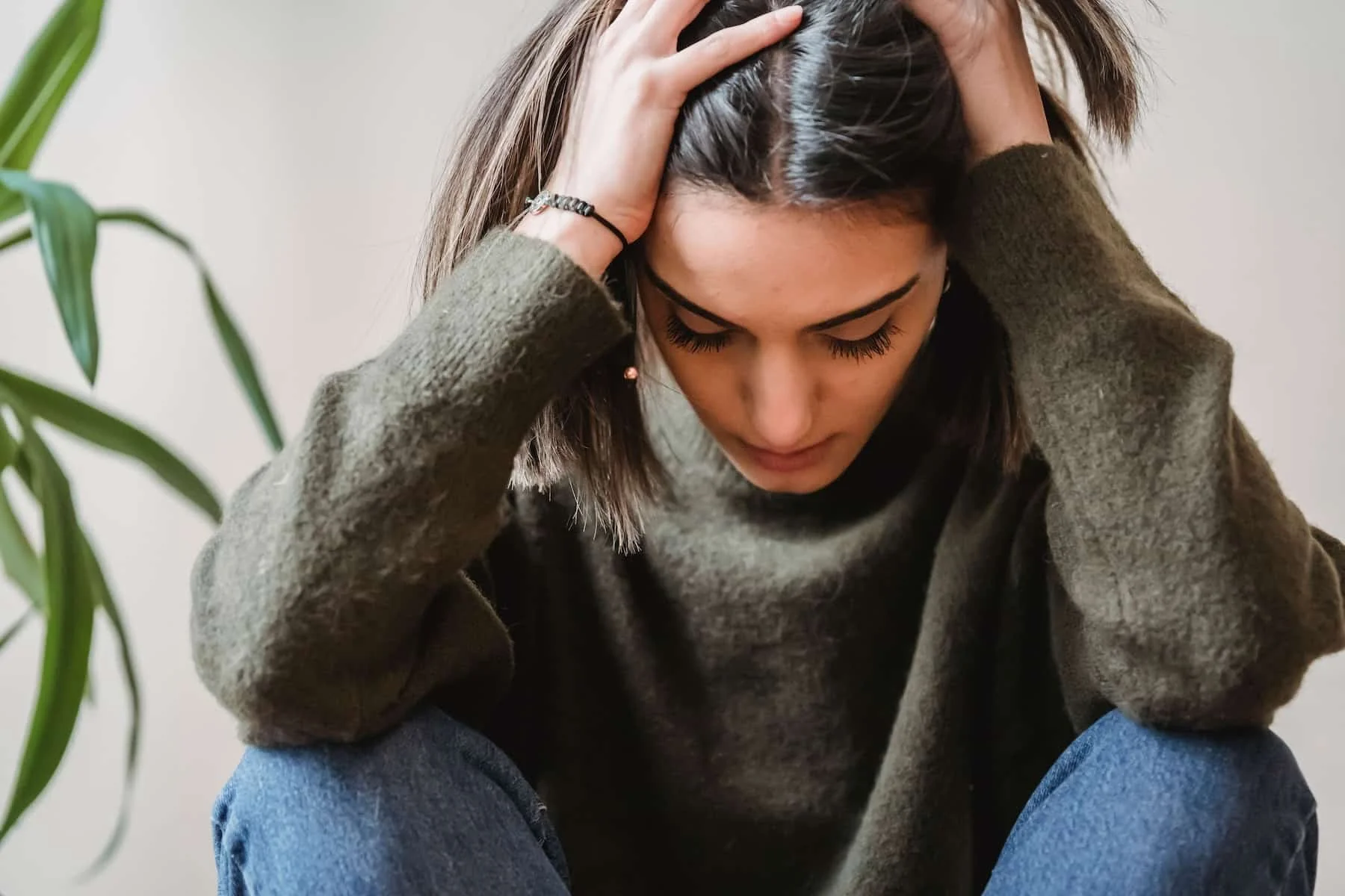 teen girl with head in hands