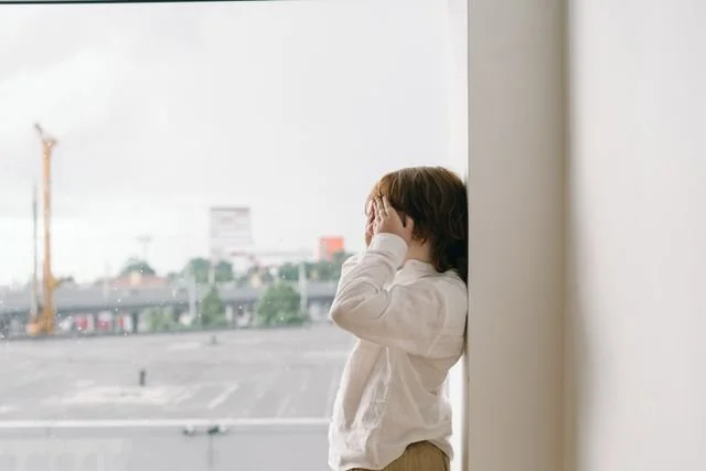 child covering eyes