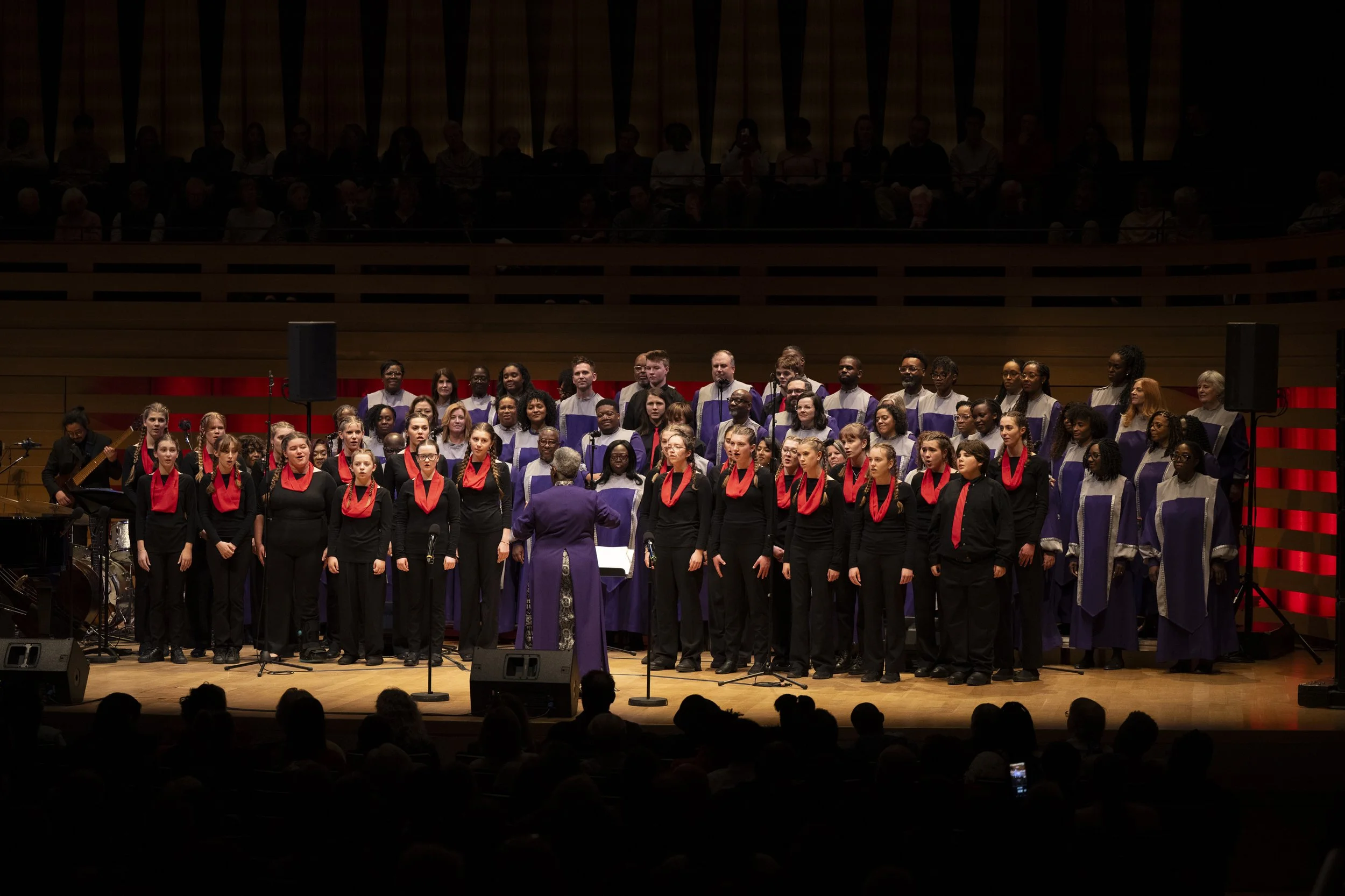 Karen Burke leading singers during a gospel choir performance