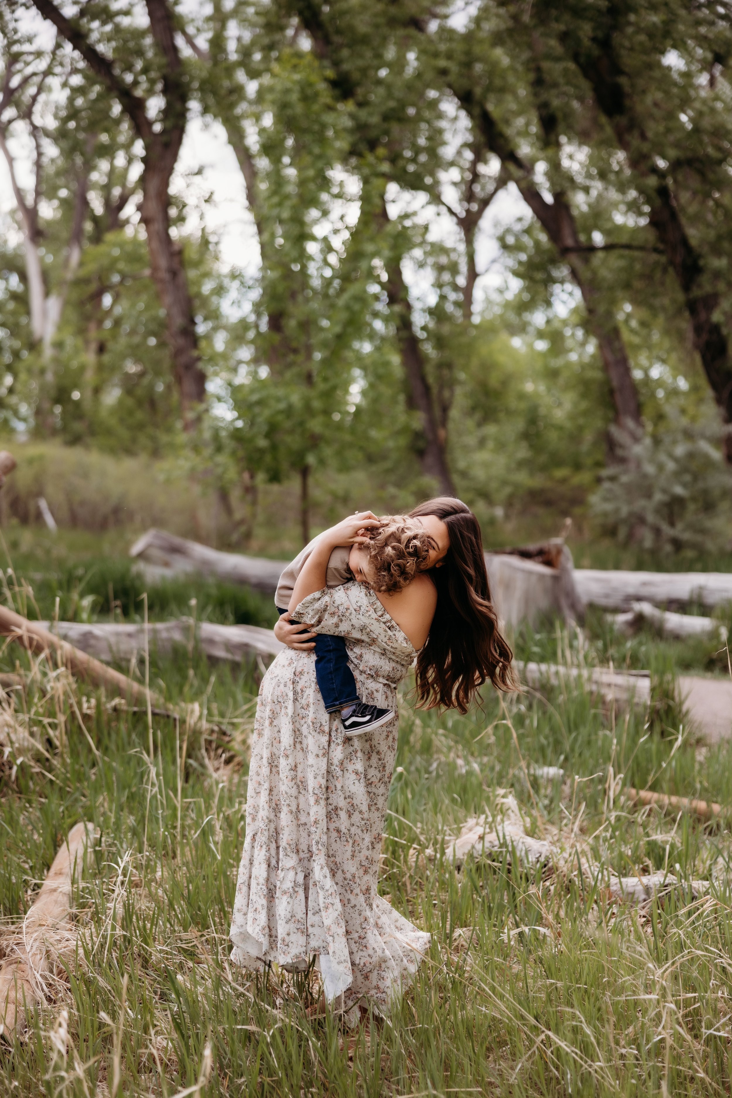 Pregnant woman embracing a toddler at East Lake Park in Thornton, Colorado.
