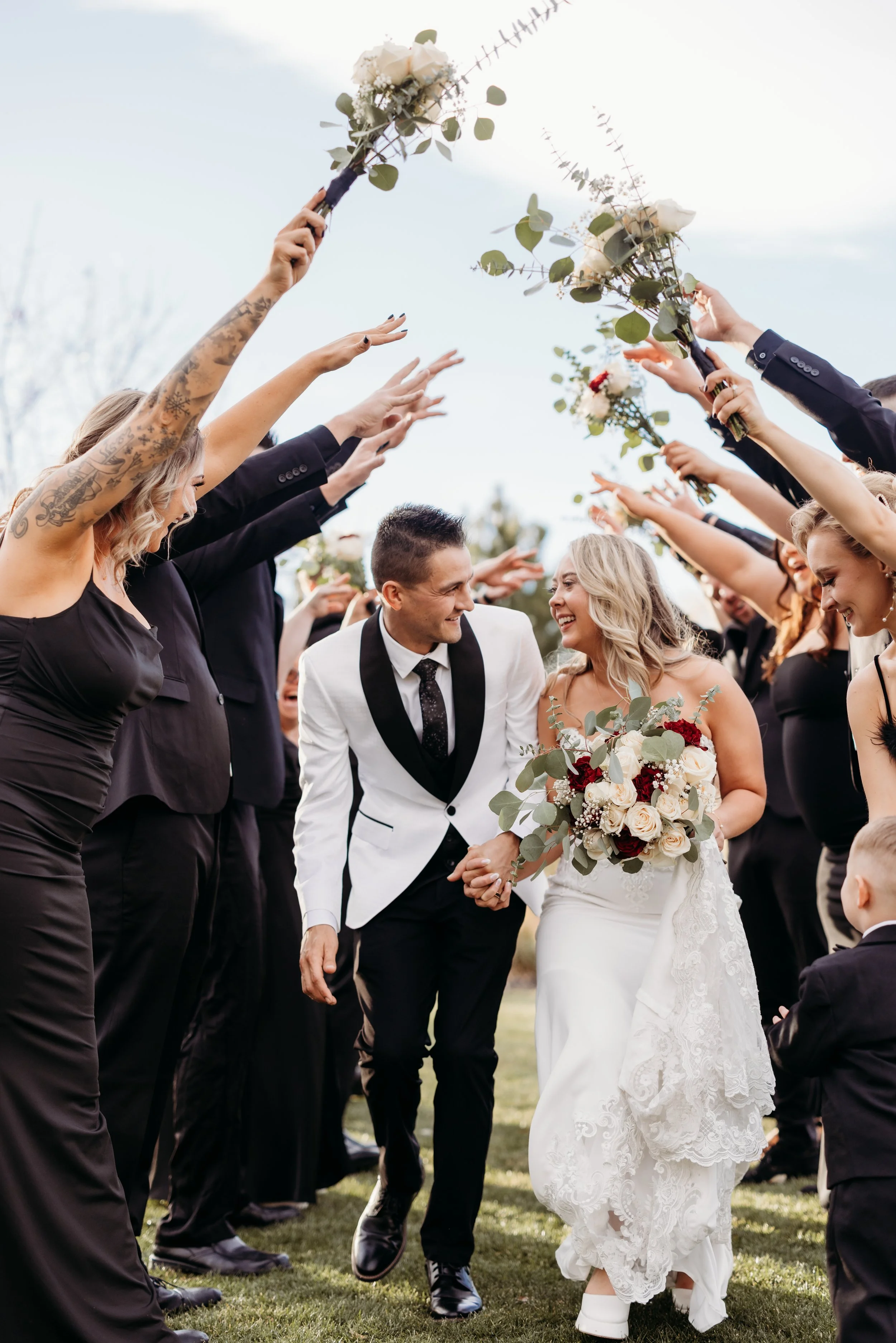 A bride and groom walking down the aisle at Applewood Golf Course.