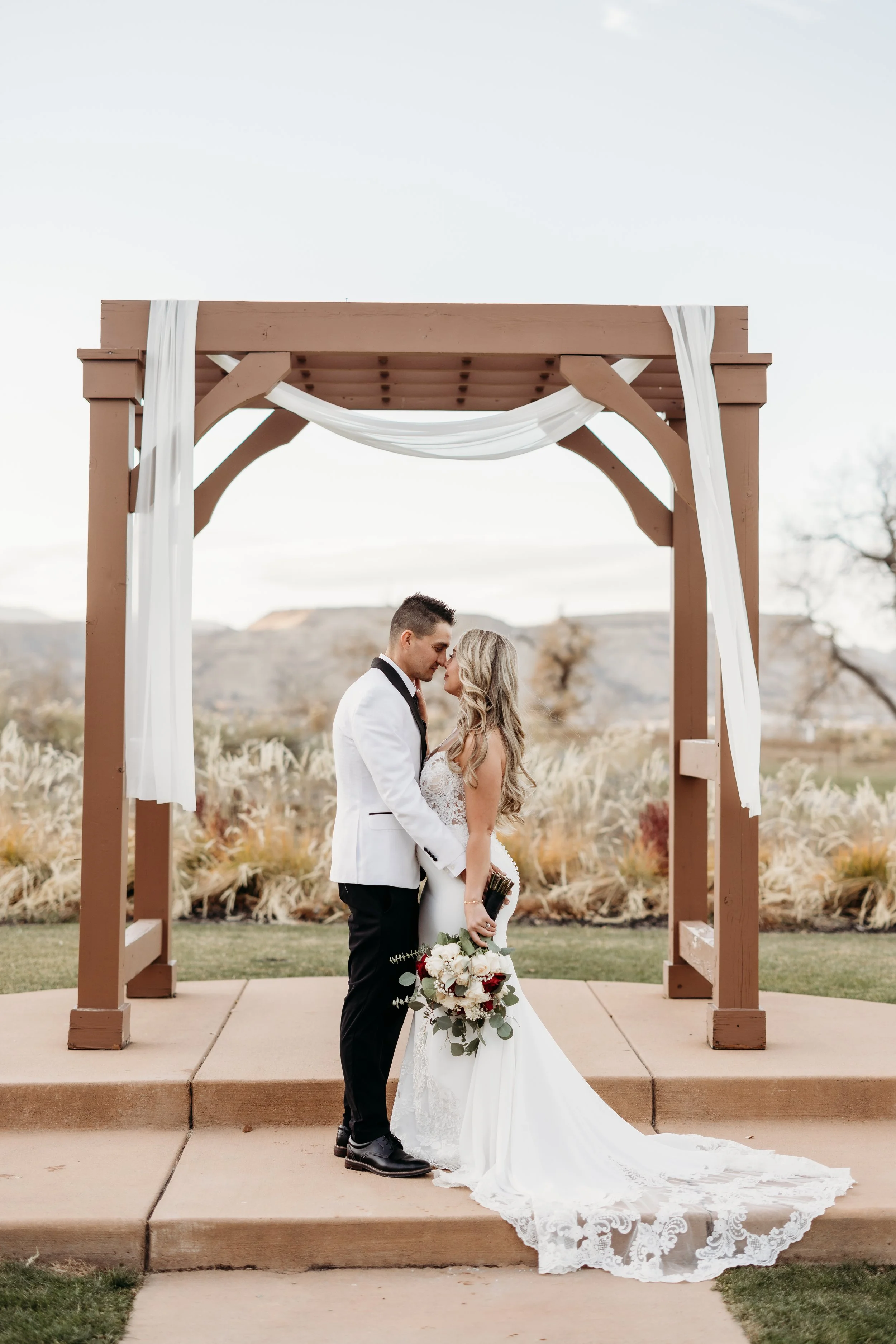 Bride and groom embracing at the altar at the Applewood Golf Course.
