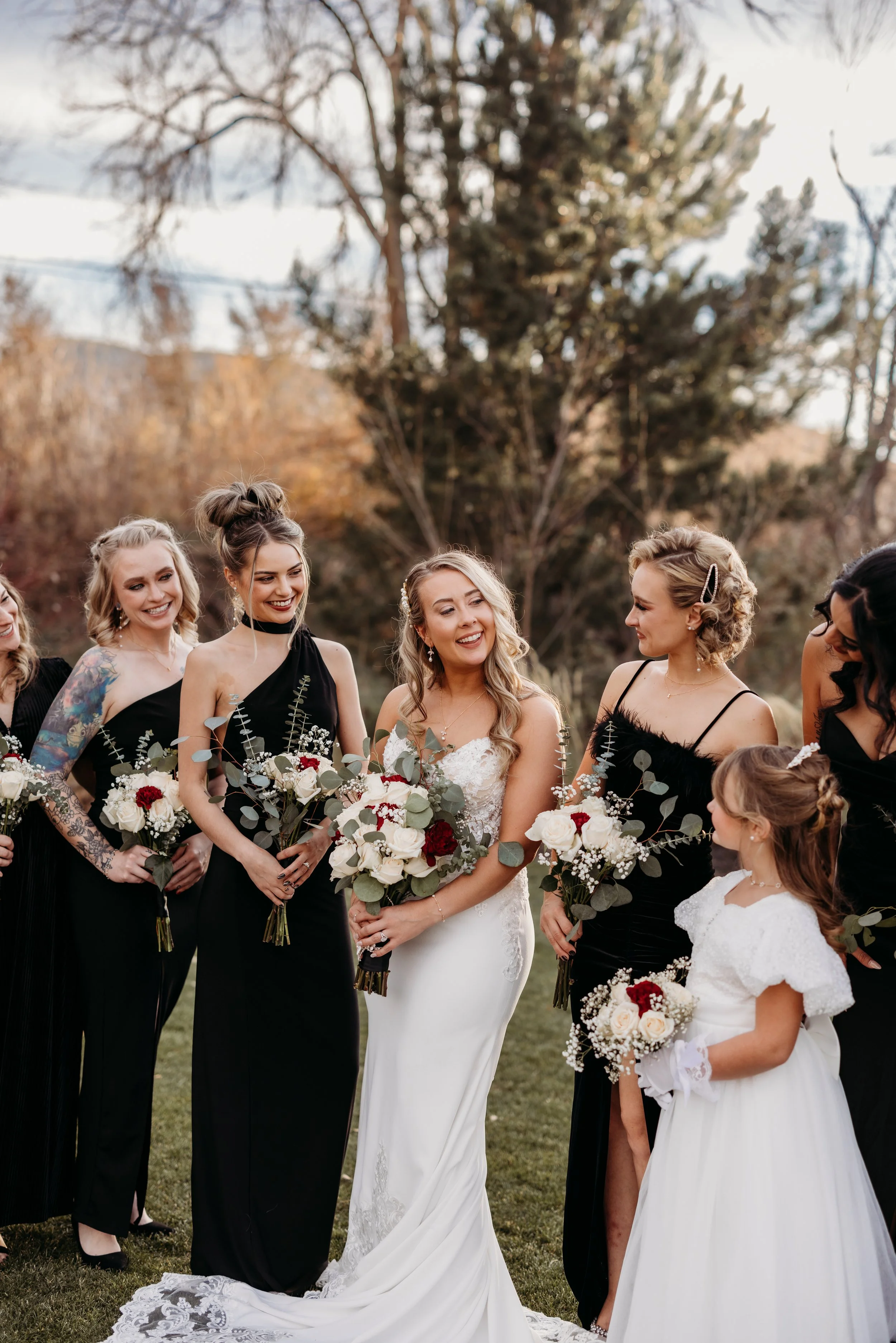 Bride smiling at her bridal party and flower girl.