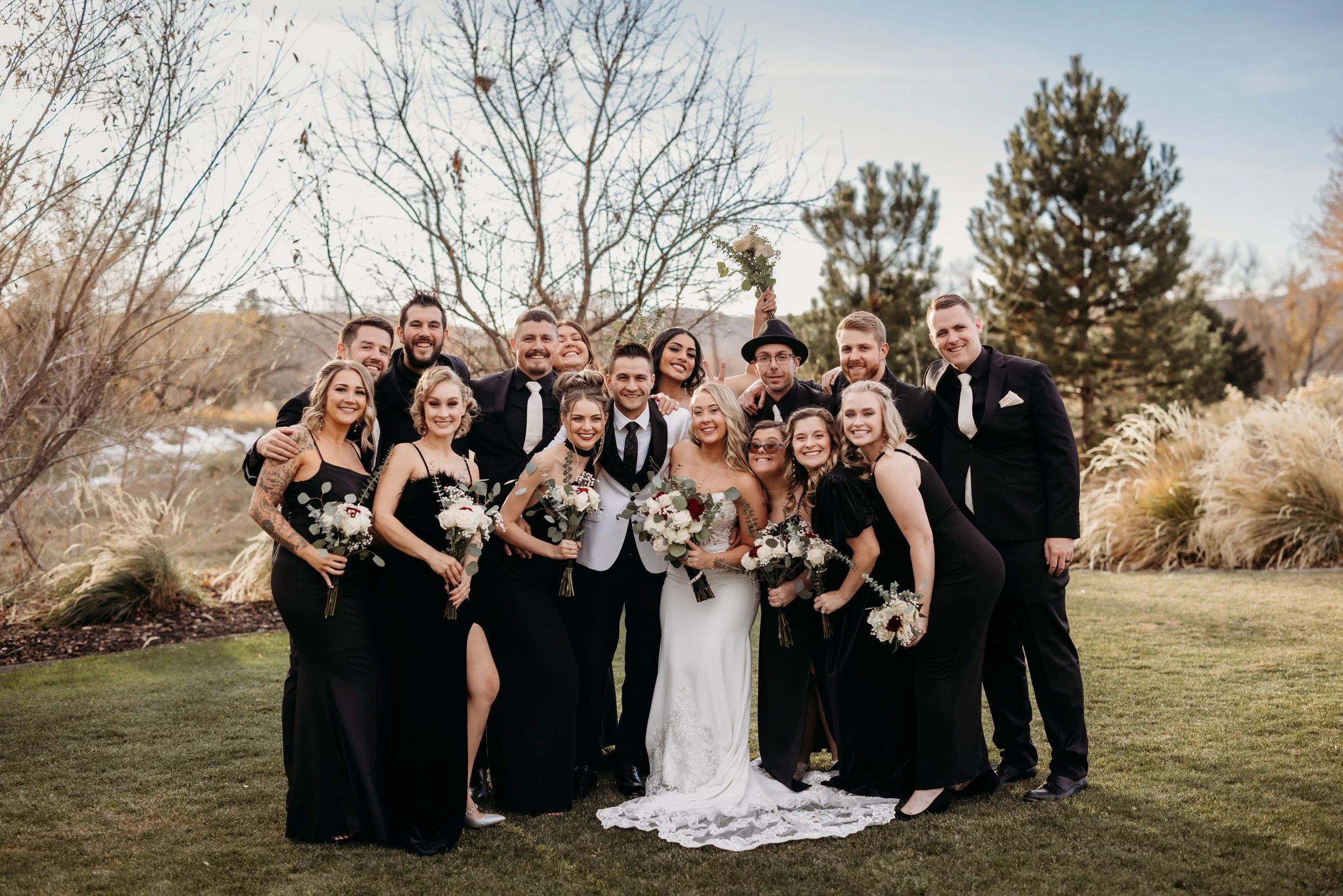 Bride and groom posing with their wedding party at Applewood Golf Course.