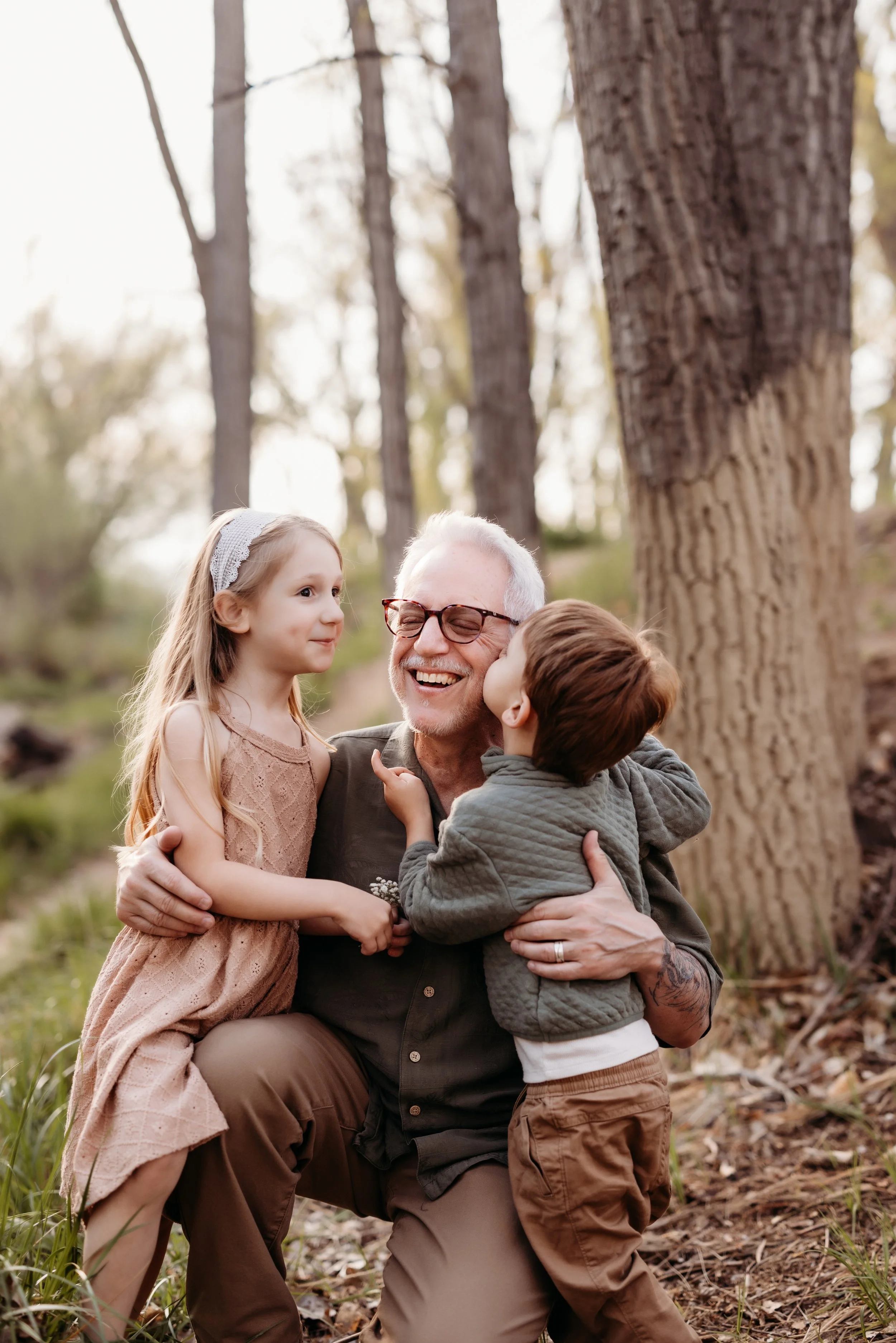 Grandfather embracing his two grandchildren.