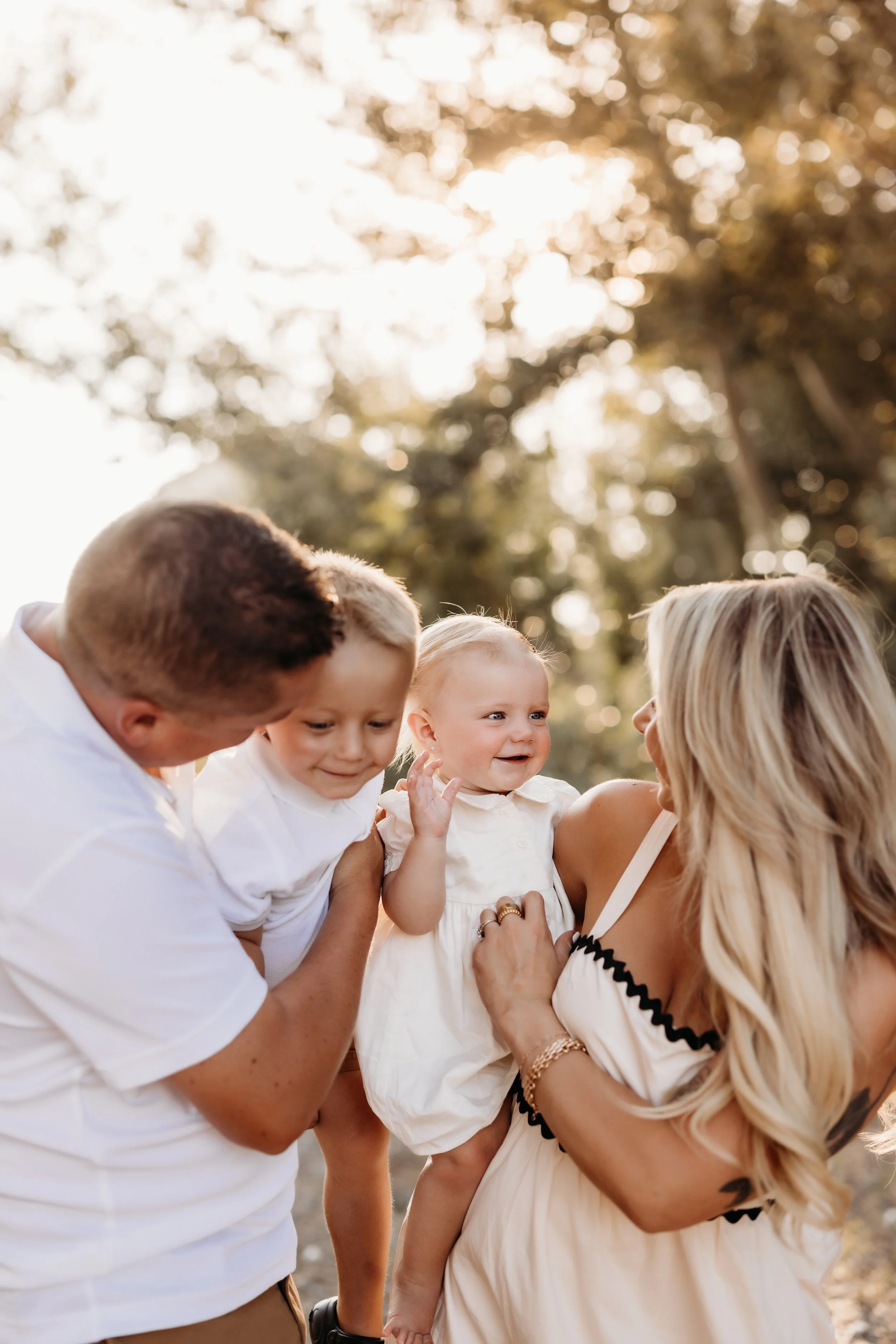 Parents and their two kids embracing.