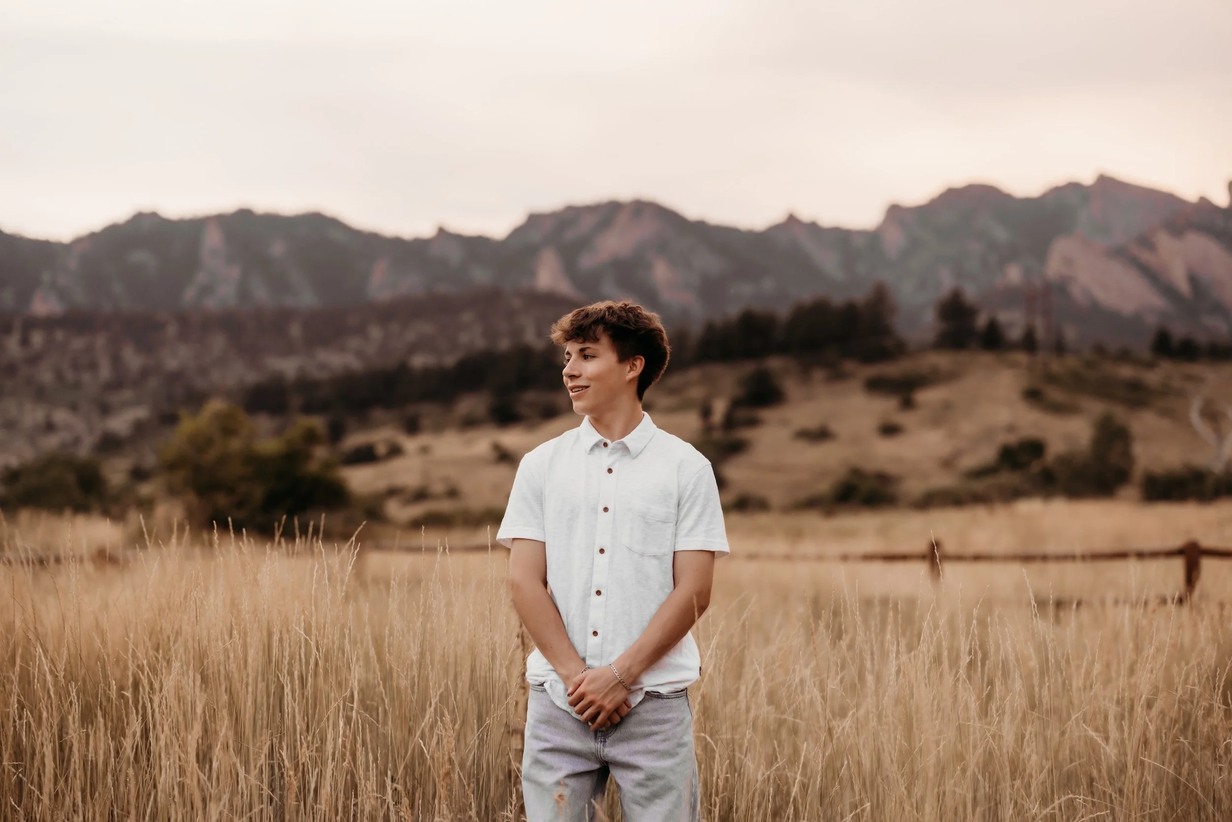 Teenage boy posing in front of a mountain range in Boulder, Colorado.