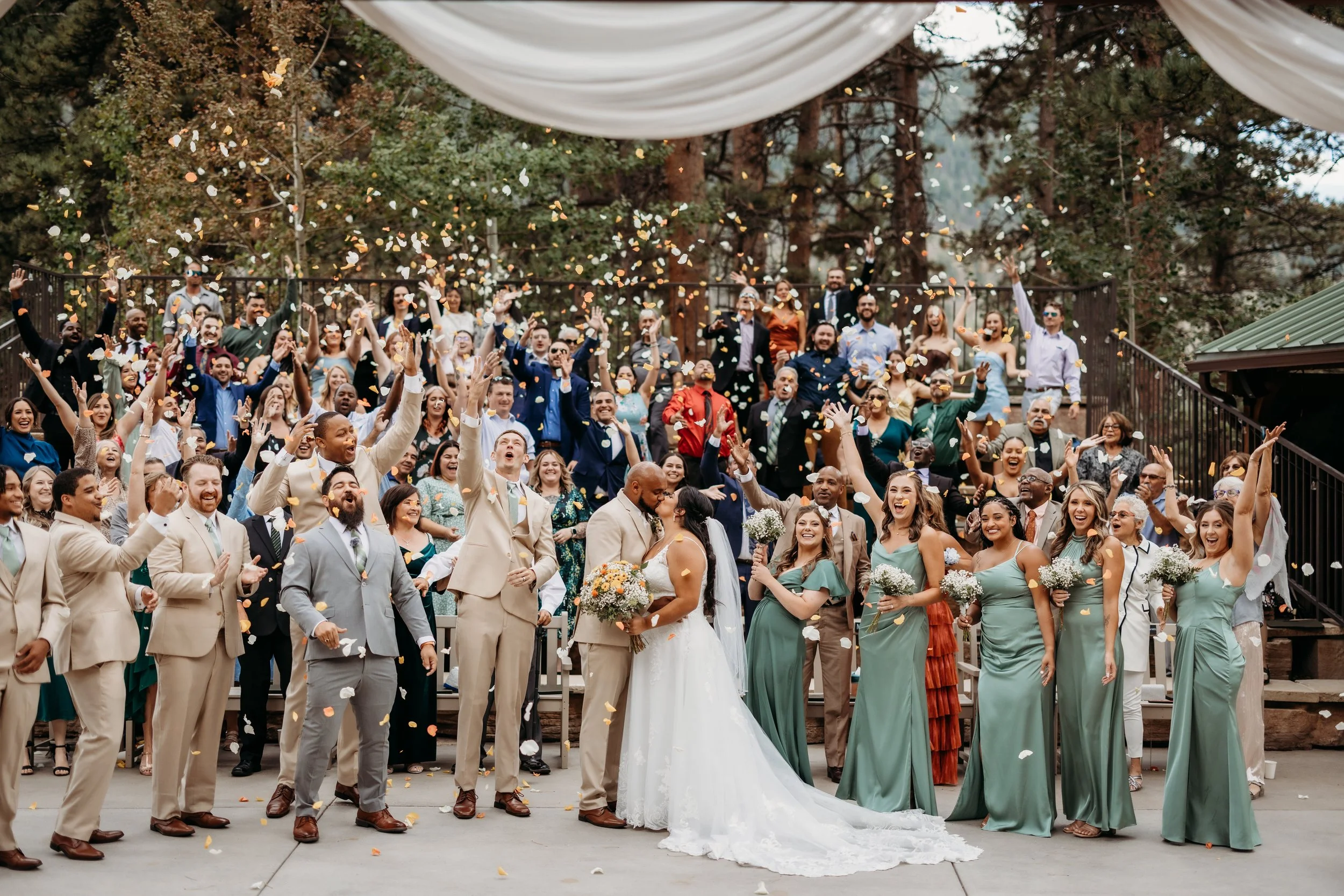 Wedding guests celebrating with a confetti toss at Della Terra Mountain Chateau in Estes Park, Colorado.