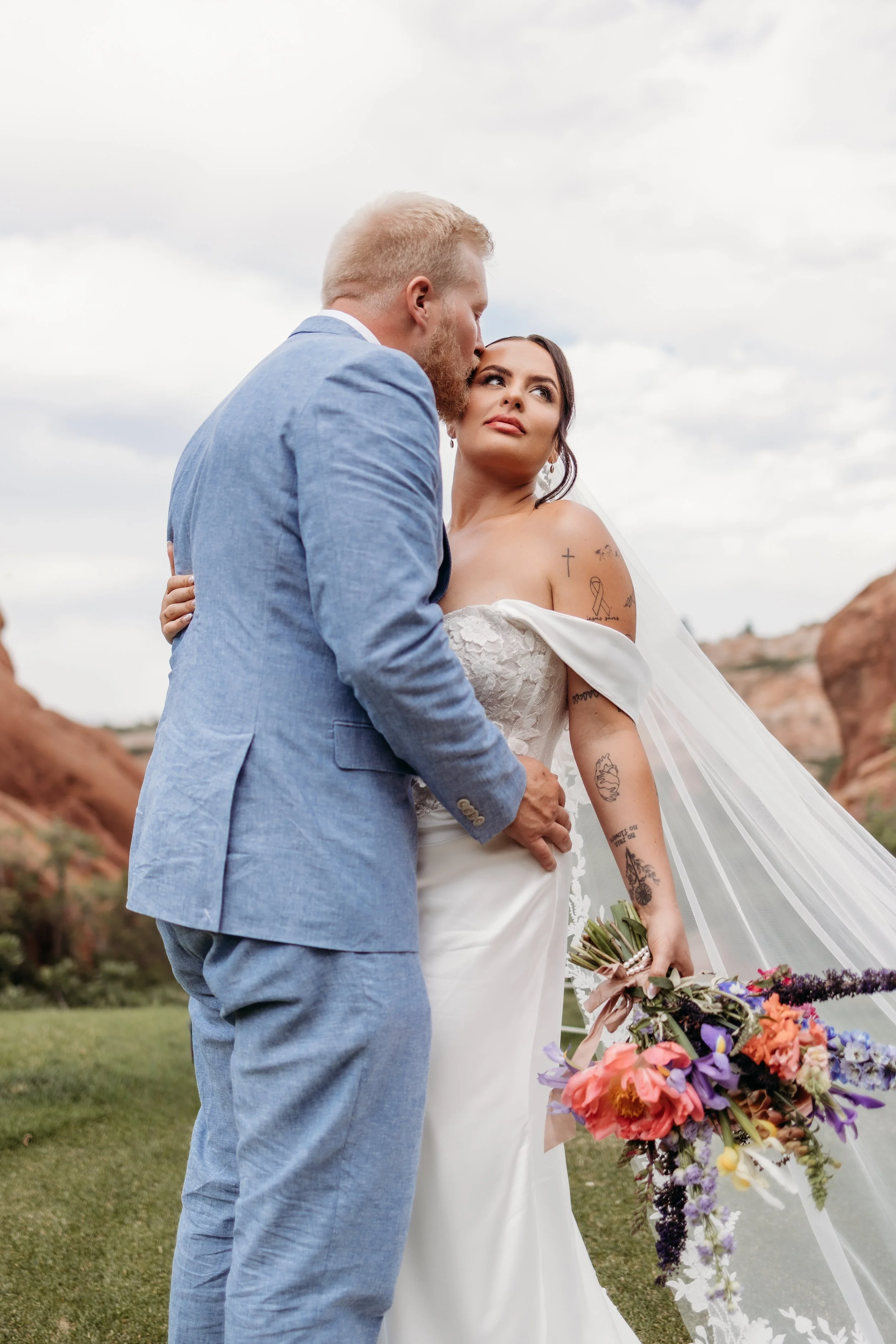 Bride and groom embracing at Arrowhead Golf Course.