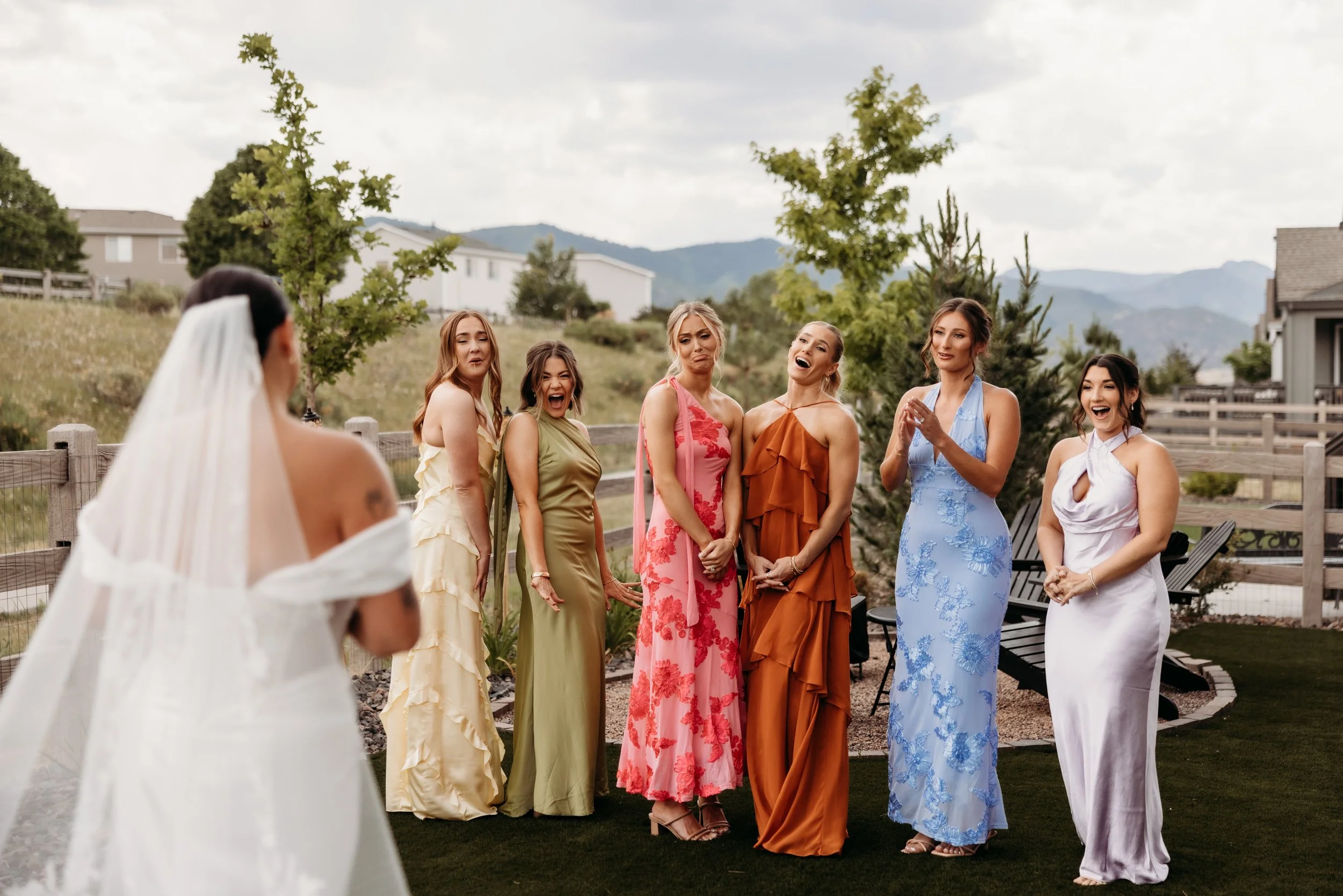 Bridesmaids looking at the bride and smiling.