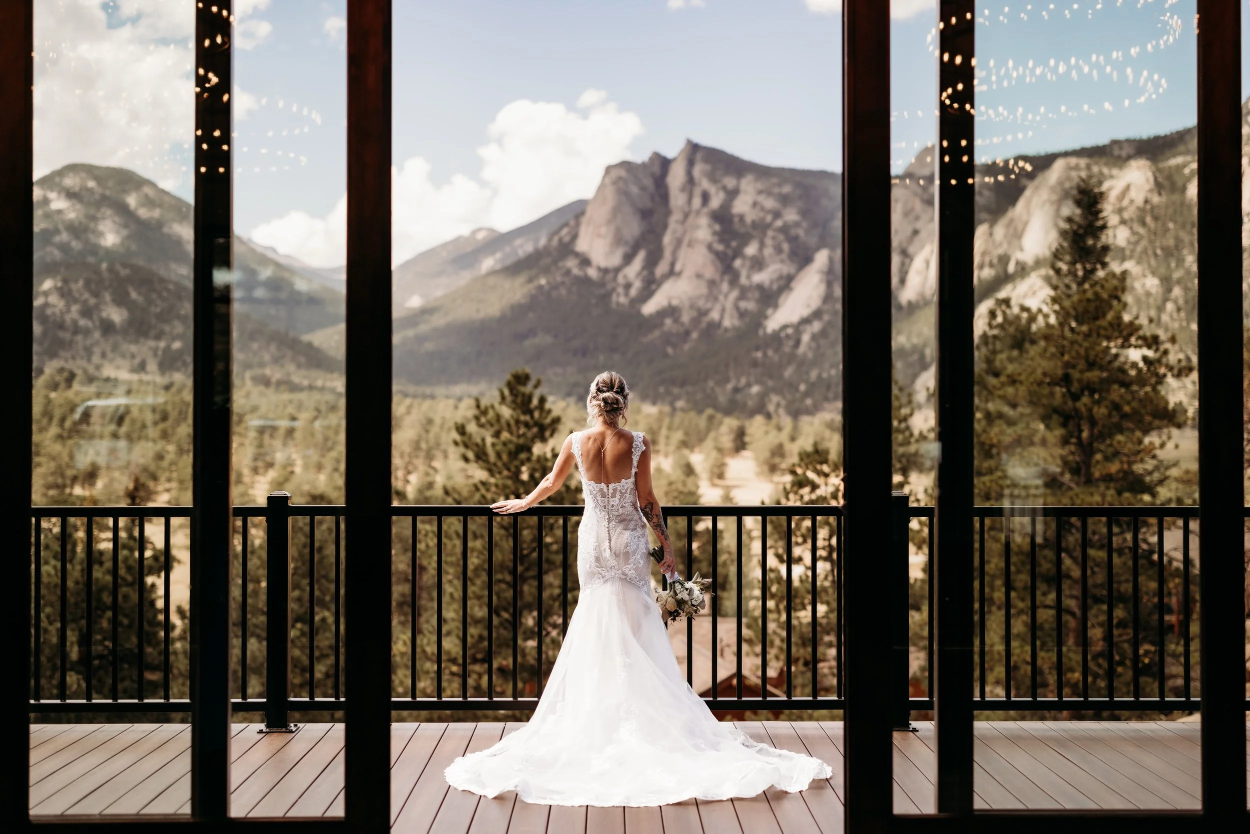 Bride on a balcony looking out at the Black Canyon in Estes Park, Colorado.