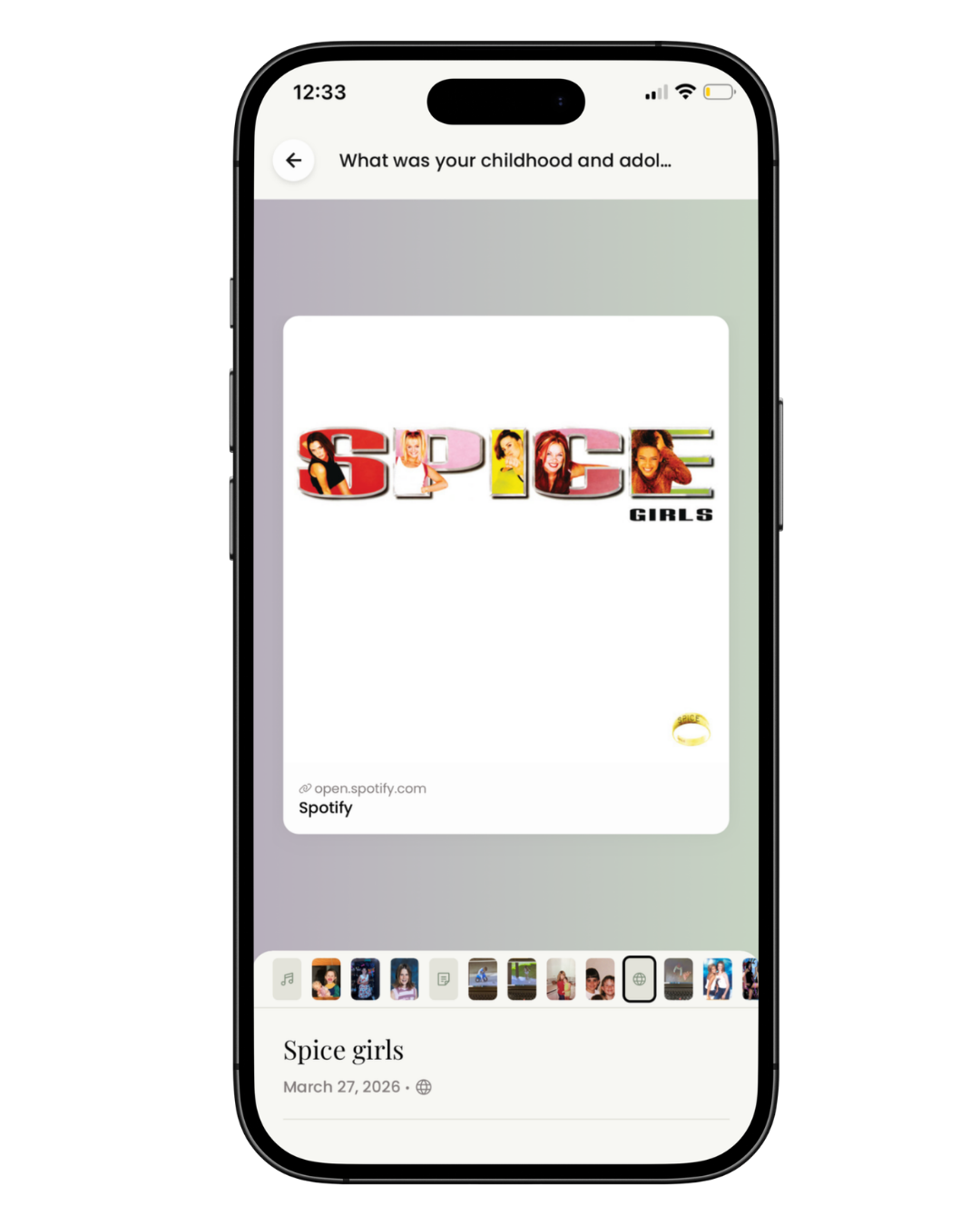 A smartphone screen displaying an album cover for 'Spice Girls' with the title spelled out using images of the band members inside the letters. The cover has the words 'SPICE GIRLS' and a Spotify link at the bottom. The phone shows a time of 12:33 and various app icons at the bottom.