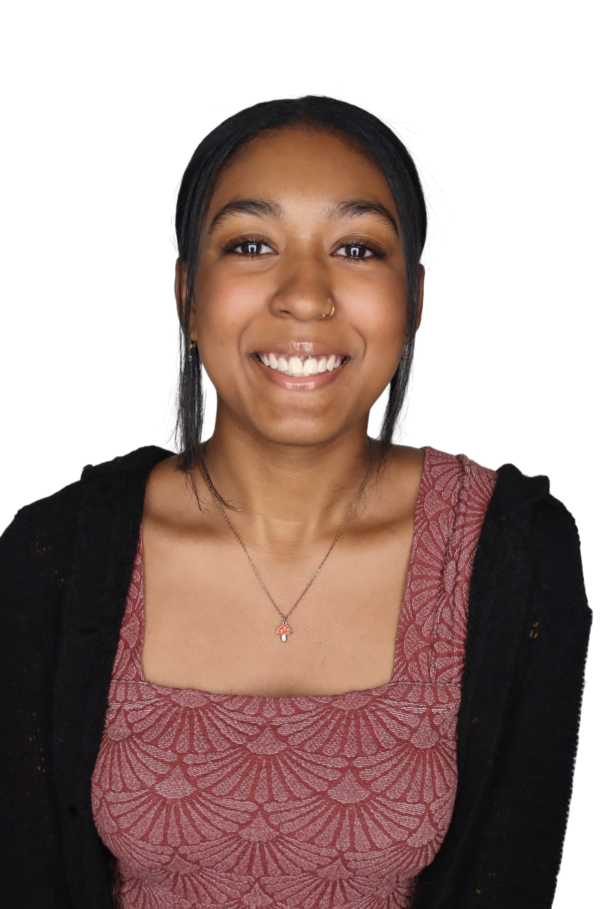 Close-up of a young woman with medium skin tone, black hair, gray eyes, wearing a mushroom-shaped umbrella necklace, a lace-patterned reddish top, and a black cardigan.