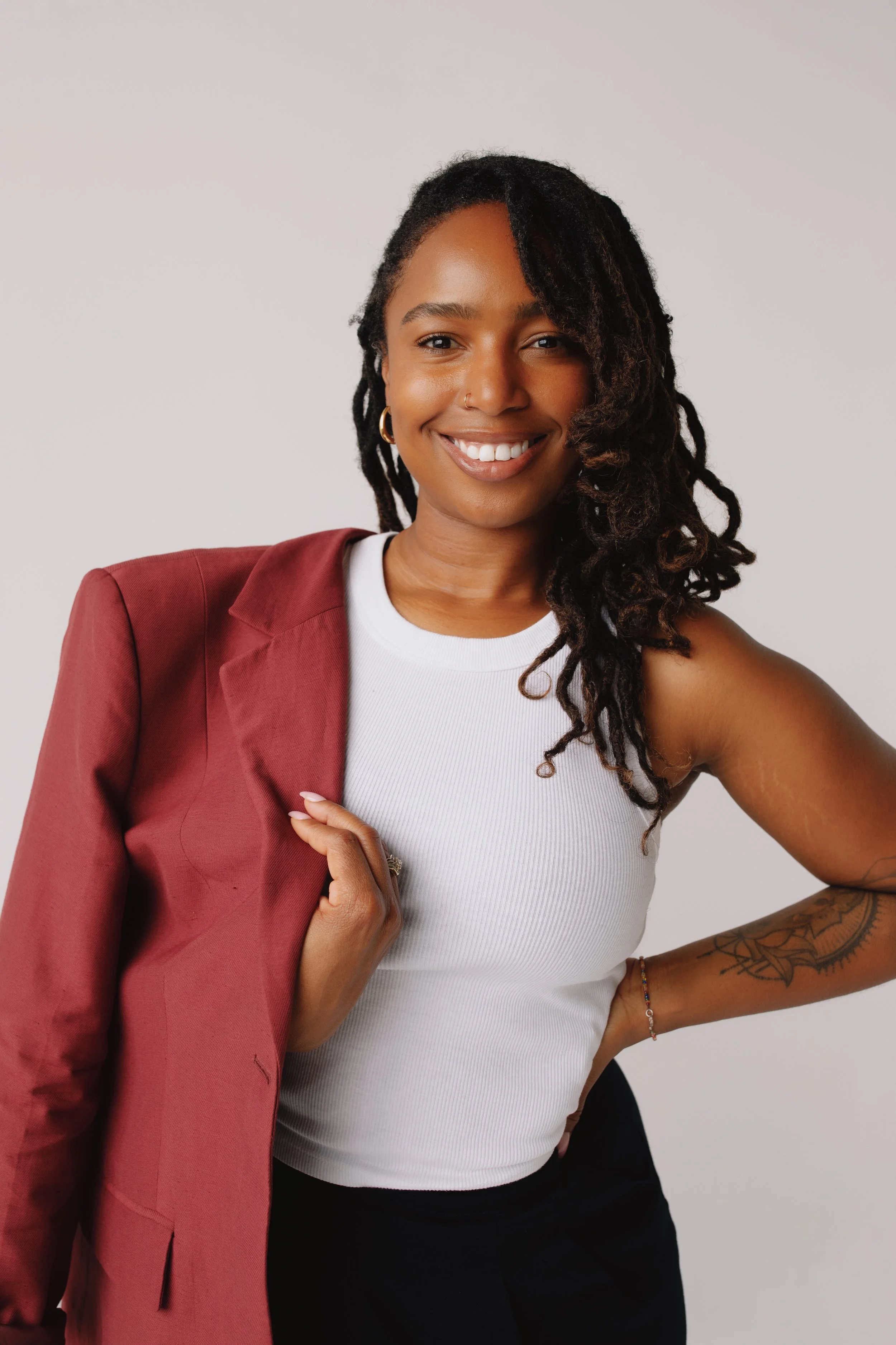 Gena, an online sex therapist in California, standing and smiling at camera.
