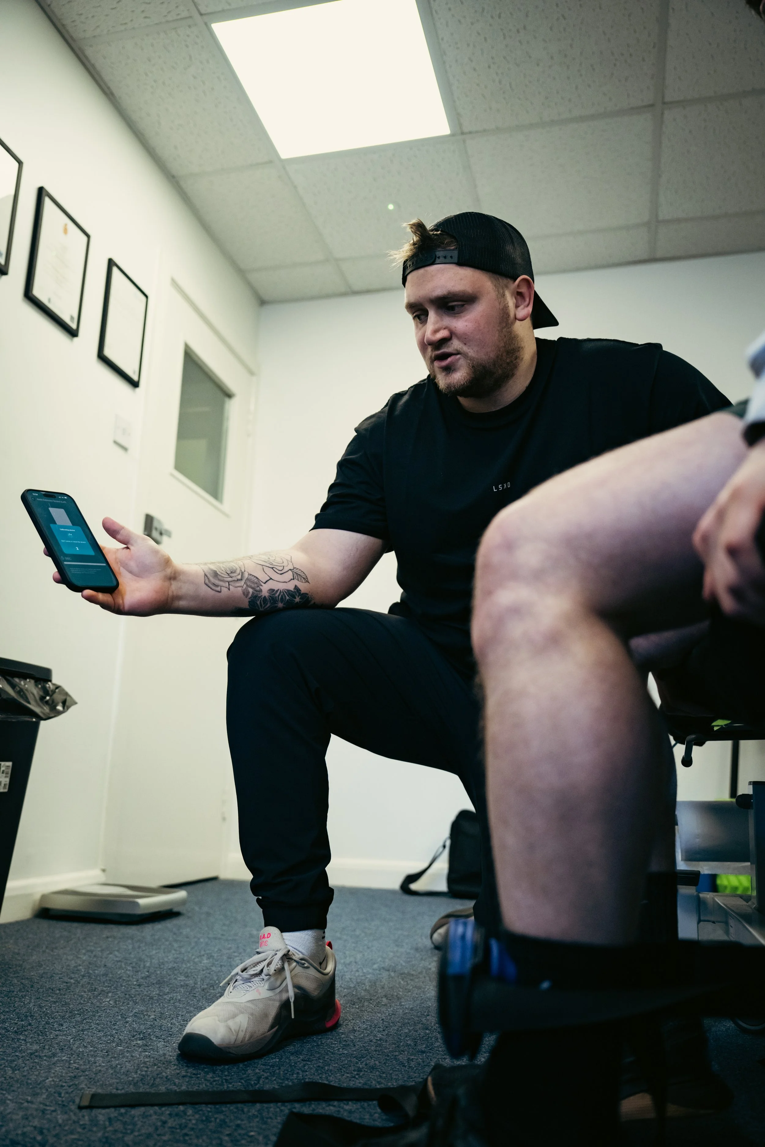 Sports therapist assessing a client during a treatment session in Winchester.
