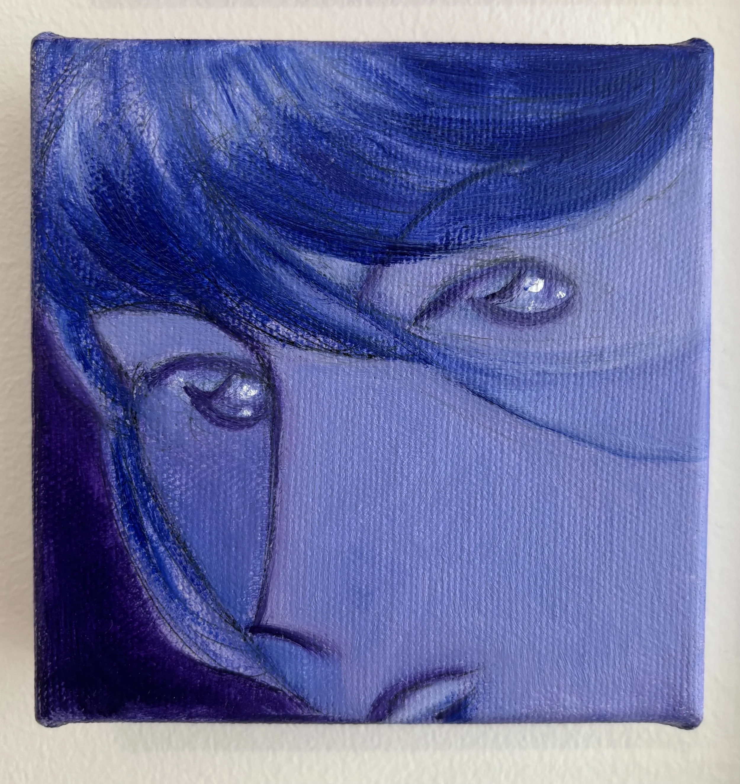 Close-up of a small canvas painting with swirling abstract blue and purple brushstrokes.