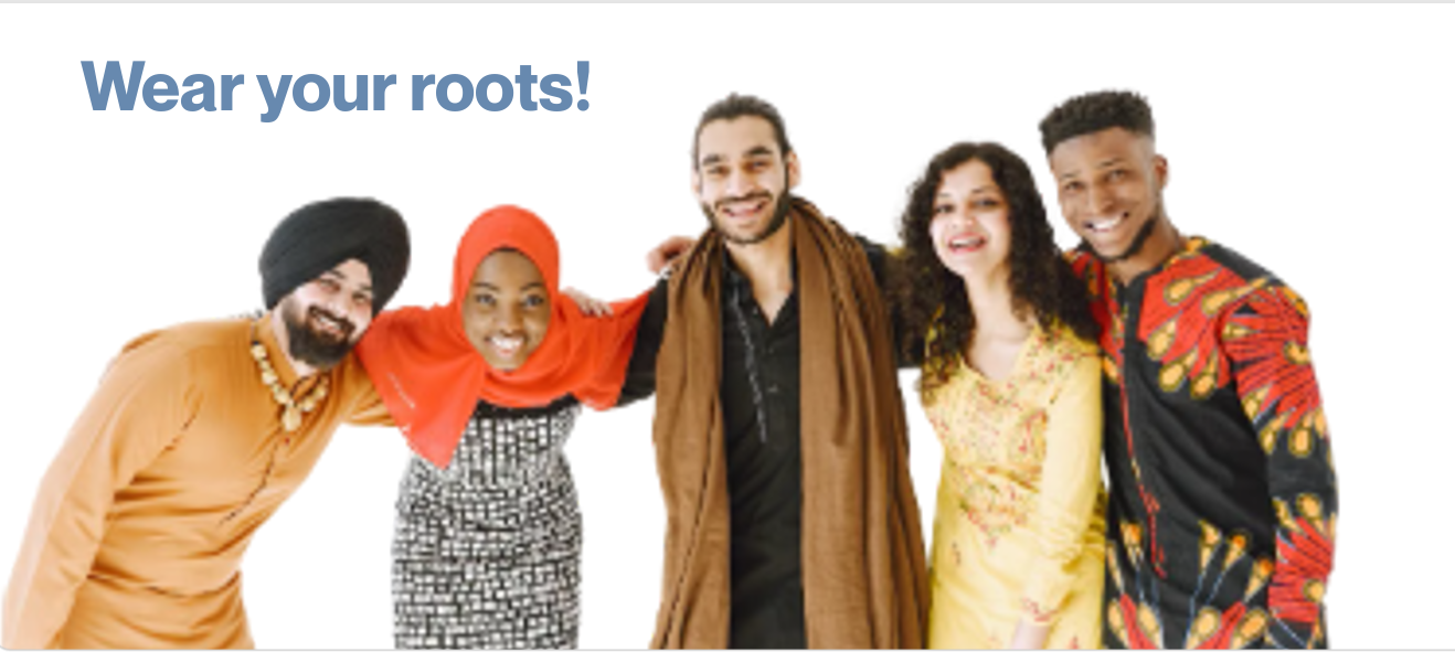 A group of adults of different religions stand huddled together smiling at the camera