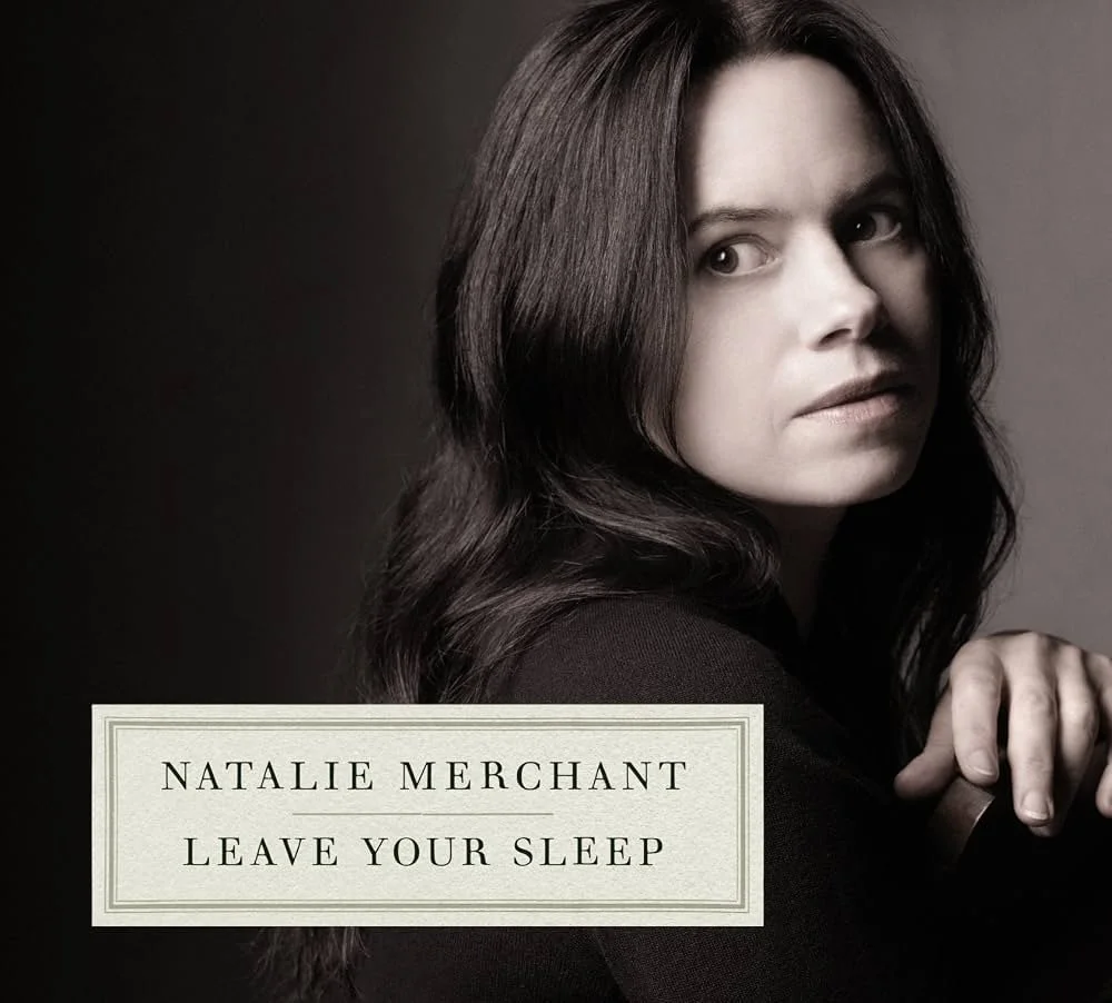 Album cover of Leave Your Sleep by Natalie Merchant, featuring a close-up portrait of Natalie Merchant against a dark background.
