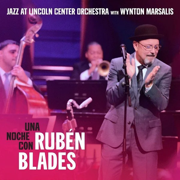 Album cover of Una Noche con Rubén Blades by Jazz at Lincoln Center Orchestra with Wynton Marsalis and Rubén Blades, featuring Rubén Blades performing on stage with the orchestra.