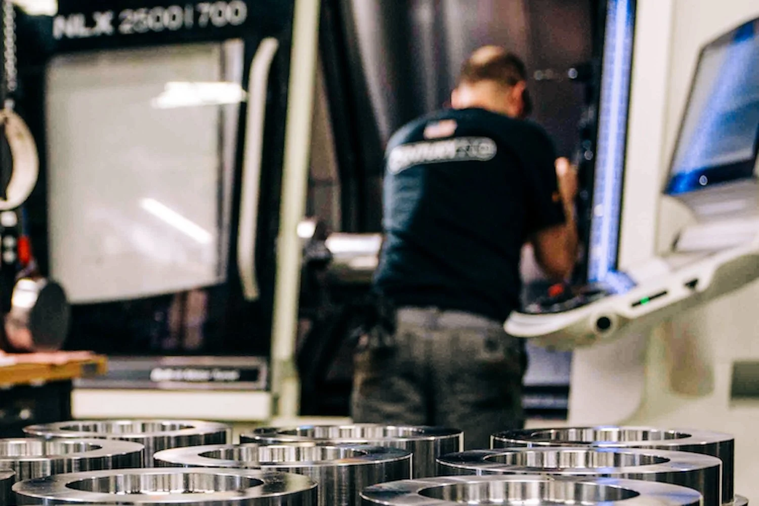 Machinist operating CNC equipment at Centurion Metalworks