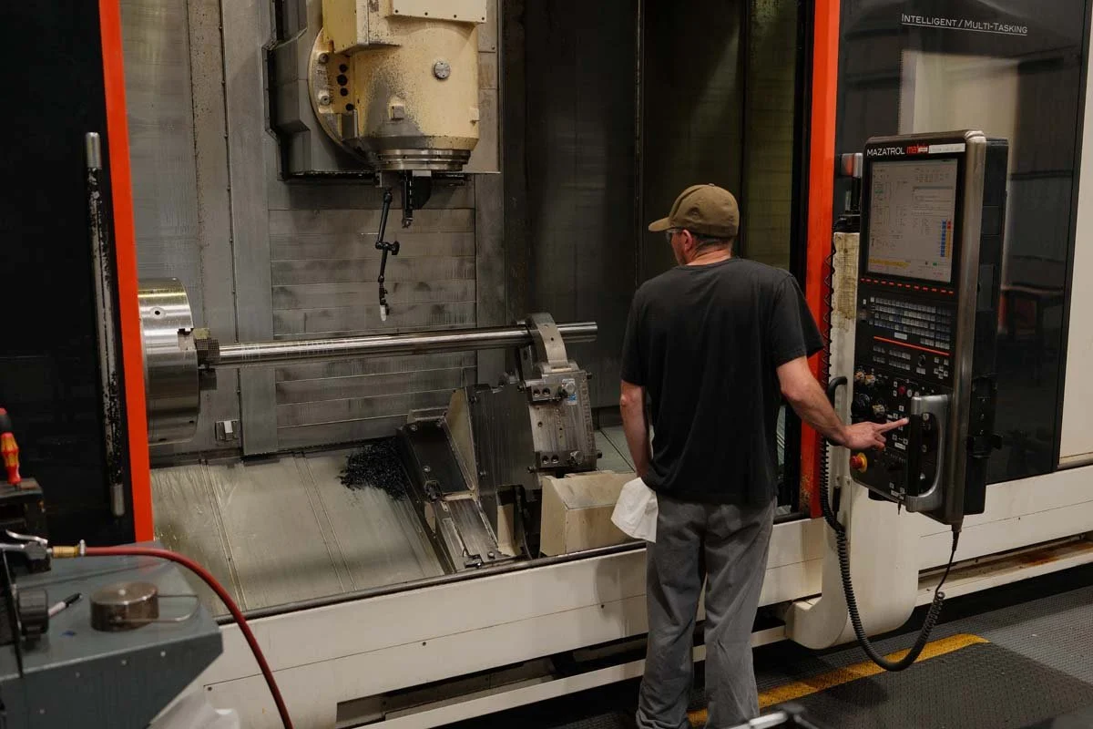 Machinist operating a CNC milling machine at Centurion Metalworks